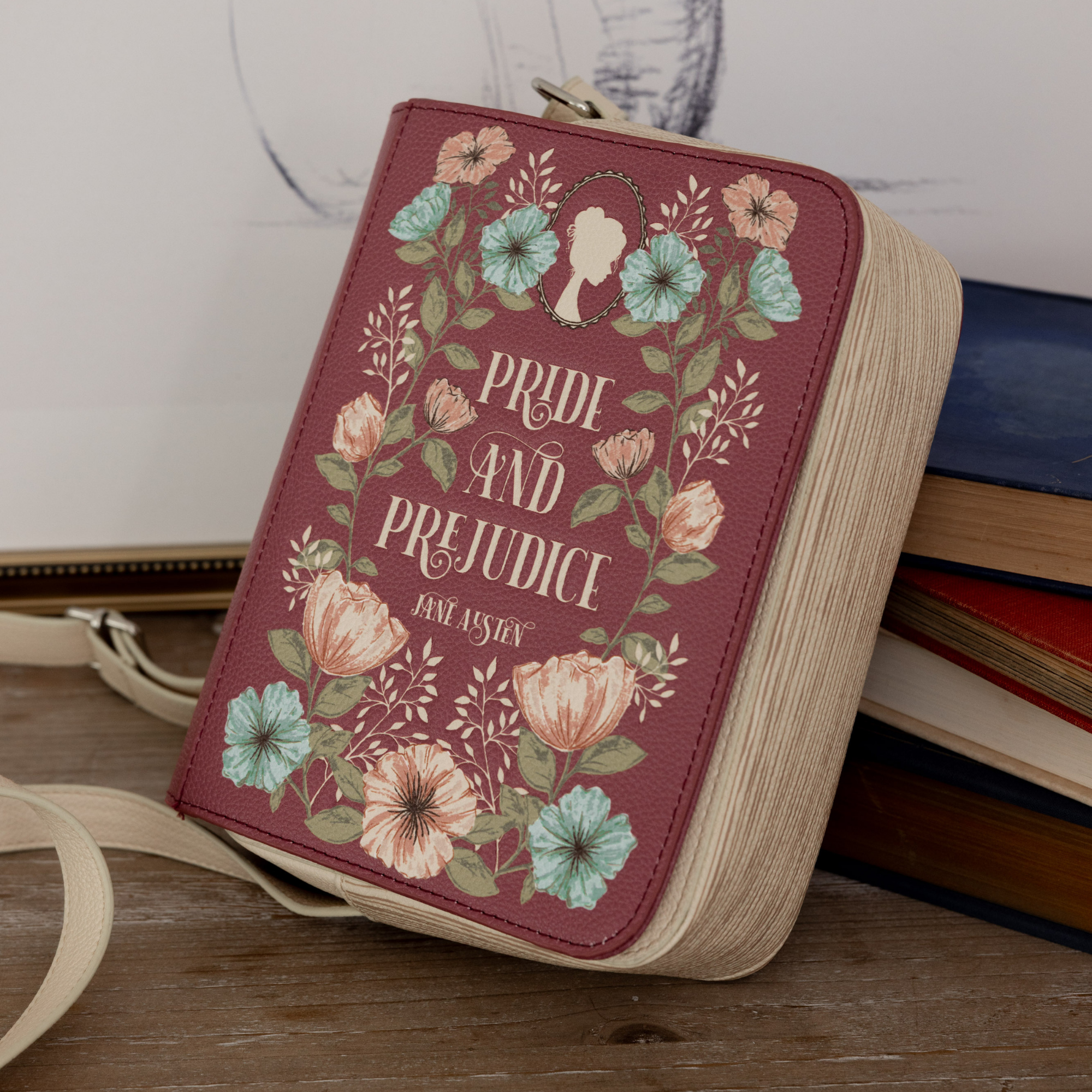 Book-shaped bag with 'Pride and Prejudice' design on a wooden surface