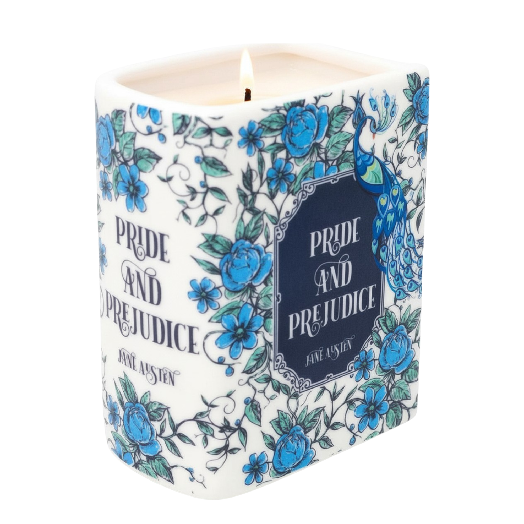 A lit white wax candle with a cylindrical body, decorated with blue roses, green leaves, and a peacock illustration. The front features a dark blue label with the text 'PRIDE AND PREJUDICE' and 'JANE AUSTIN'.