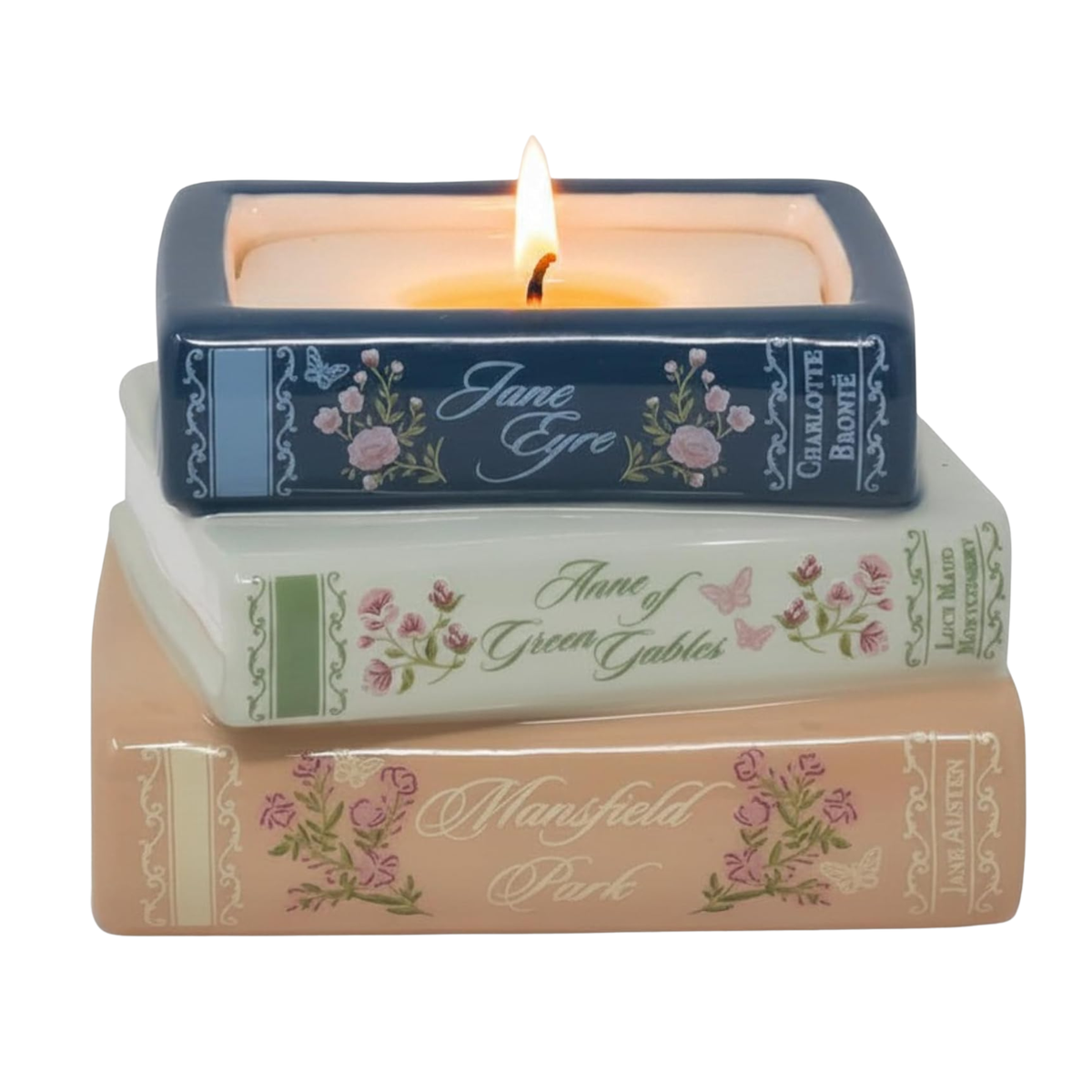 A three-tiered ceramic candle holder designed to look like stacked vintage books, with a lit tealight candle on top. The top book is navy blue with pink floral illustrations and the text 'Jane Eyre' and 'Charlotte Bronte'.