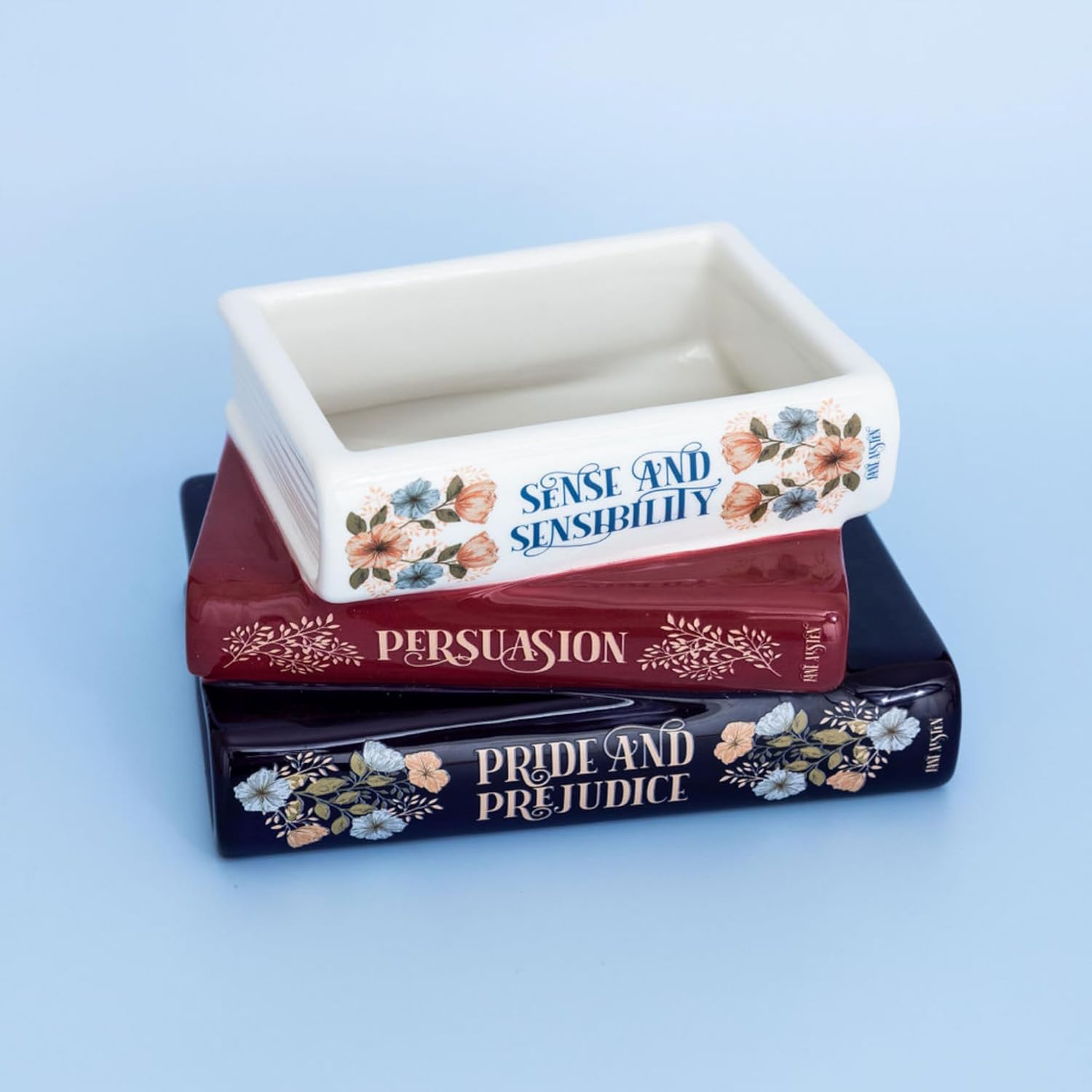 stacked book planter on a blue ground