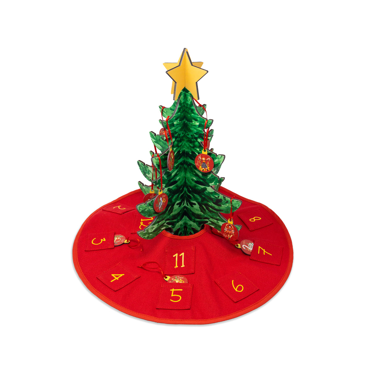 A green Christmas tree with a gold star topper, decorated with red ornaments, standing on a red circular advent skirt with numbered gift bags around it, isolated on a white background.