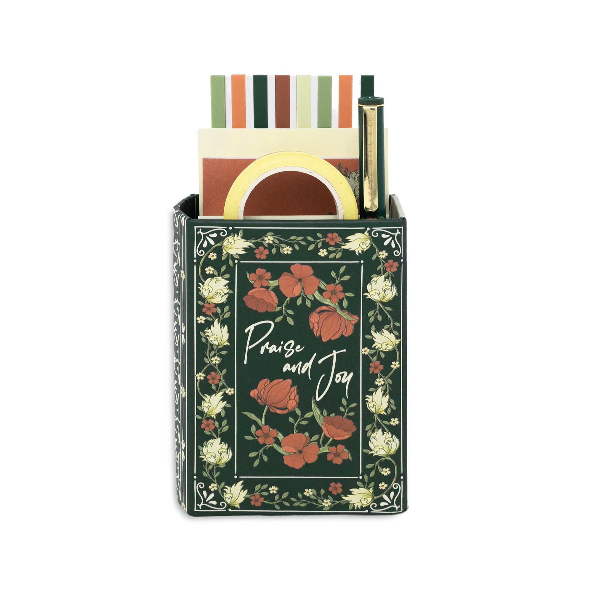 A decorative rectangular storage box with a floral print in dark green, terracotta, and cream, featuring the words 'Praise and Joy' in white script. The box is shown holding stationery items, including striped cards, a yellow circular item, and a gold pen, against a plain white background.