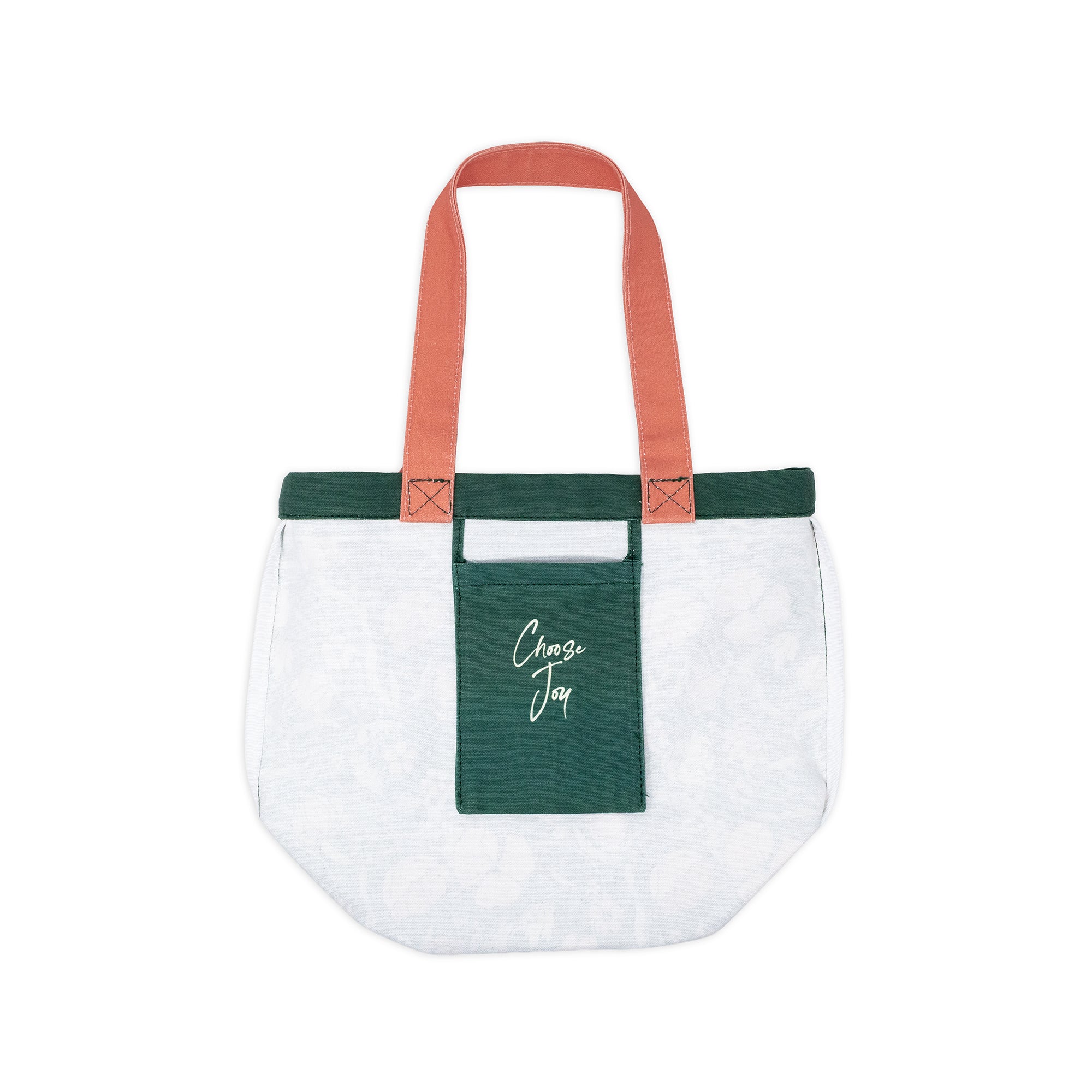 A white canvas tote bag with a dark green front pocket featuring the white script text 'Choose Joy'. The bag has dark green trim along the top edge and handles made of a contrasting coral-pink fabric.