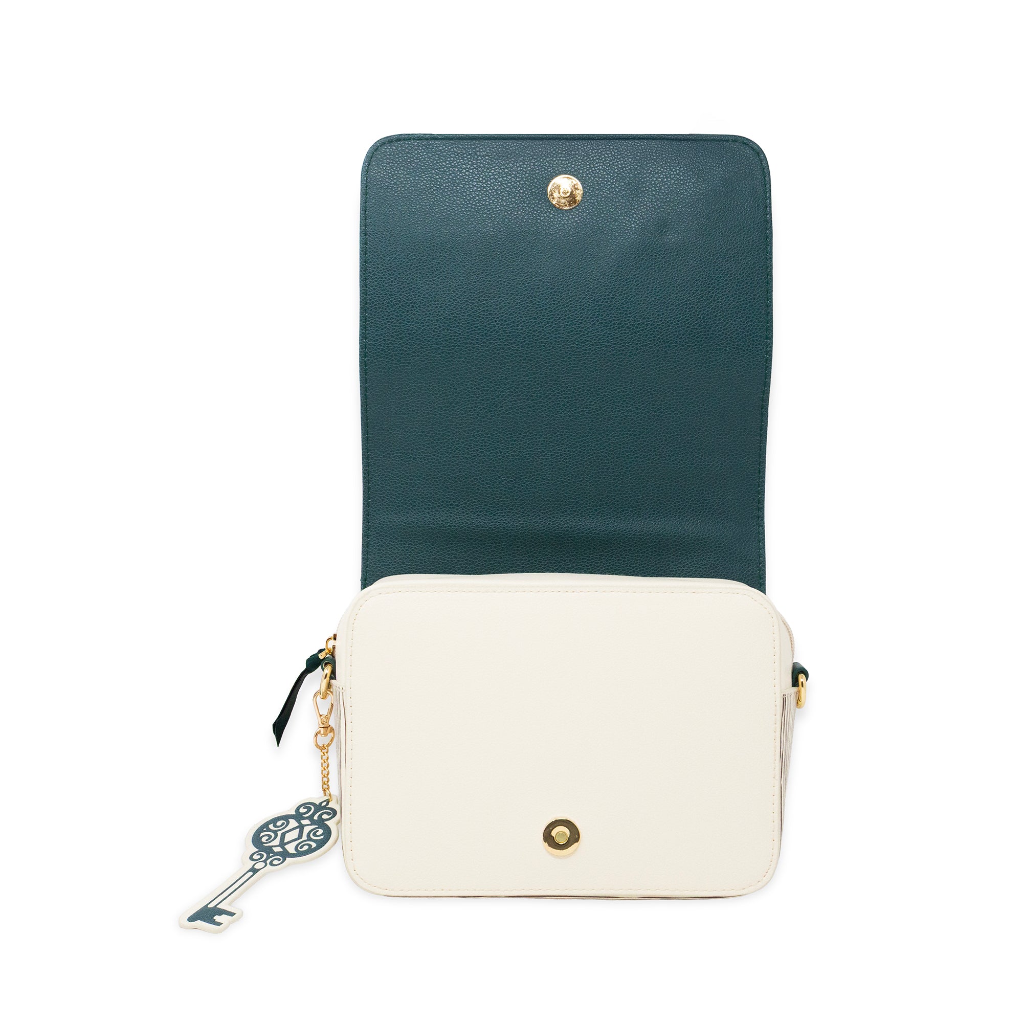 A two-tone crossbody bag with a dark teal upper flap and an off-white lower body, featuring gold-tone hardware and a decorative key charm.