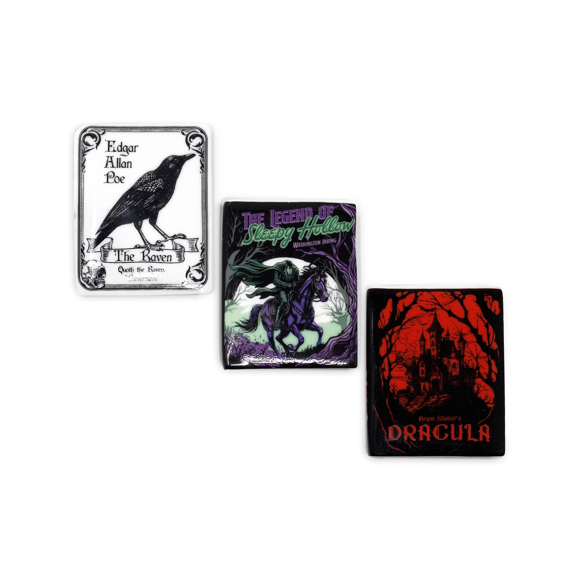Three gothic-themed square magnets arranged on a plain white background: one with a black raven and the text 'Edgar Allan Poe' and 'The Raven'; one with a dark horse figure and the text 'The Legend of Bloody Hallow'; one with a red haunted-house illustration and the text 'Dracula'.