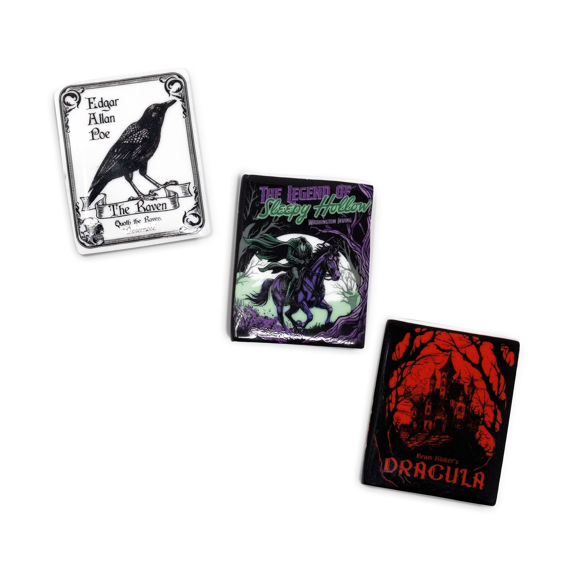 Three gothic-themed square magnets arranged on a plain white background: one with a black raven and the text 'Edgar Allan Poe' and 'The Raven'; one with a dark horse figure and the text 'The Legend of Bloody Hallow'; one with a red haunted-house illustration and the text 'Dracula'.