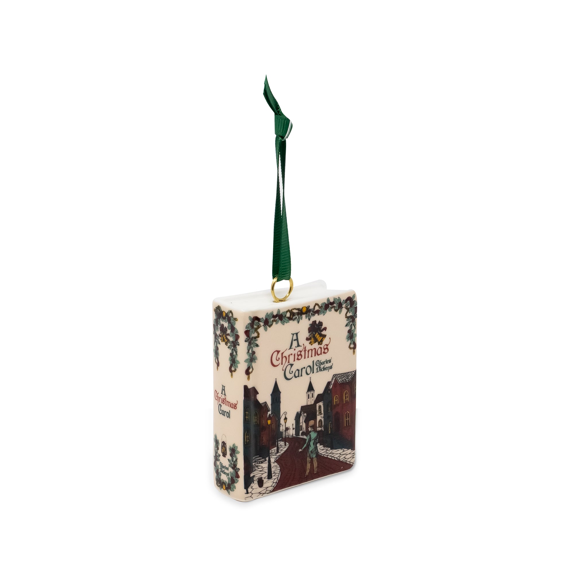 A decorative Christmas ornament shaped like a vintage book titled 'A Christmas Carol' with a dark green hanging ribbon, shown on a plain white background.