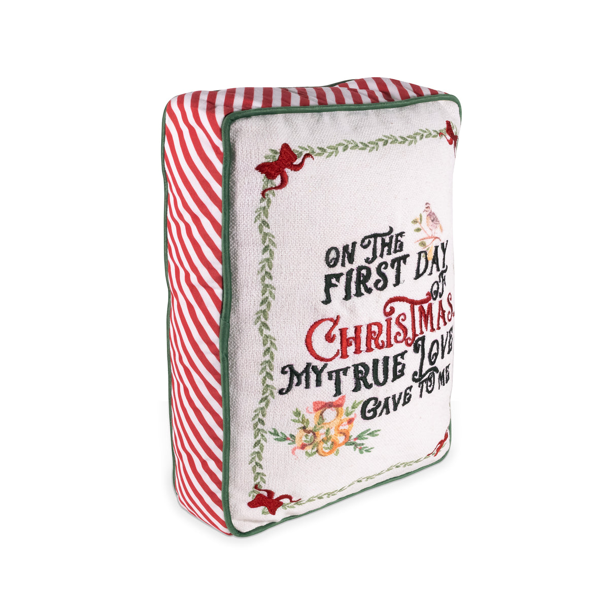A square decorative throw pillow with a festive Christmas design. The front features a white background with embroidered-style text reading 'ON THE FIRST DAY OF CHRISTMAS MY TRUE LOVE GAVE TO ME' in green and red lettering, surrounded by a green vine border with red bows and small floral details.