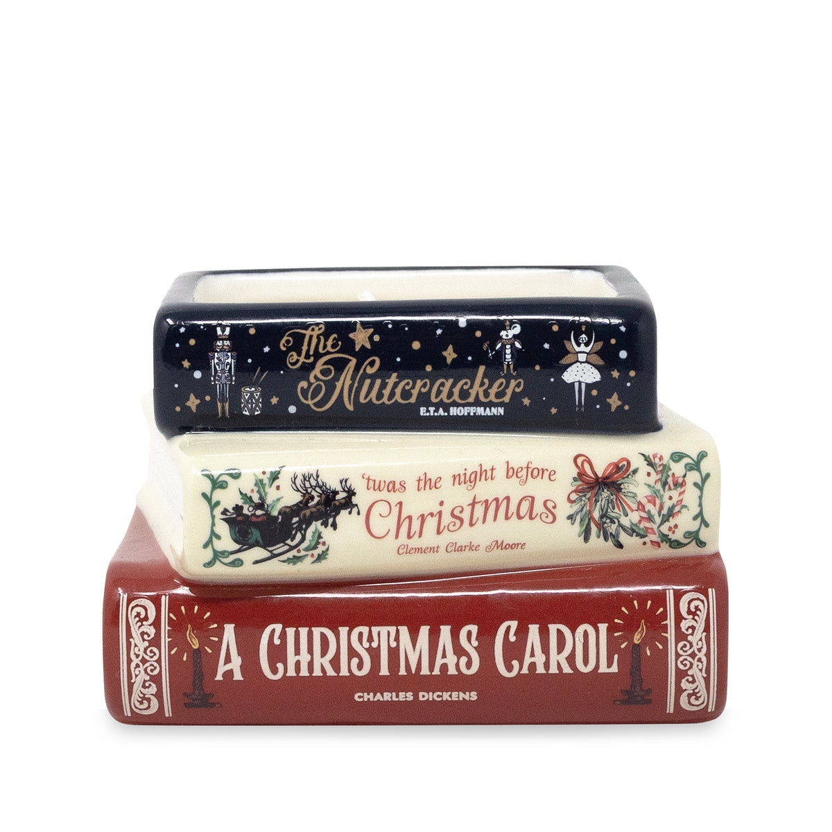 A ceramic Christmas-themed book stack figurine featuring 'The Nutcracker' on top, followed by 'The Night Before Christmas', and 'A Christmas Carol' on the bottom.