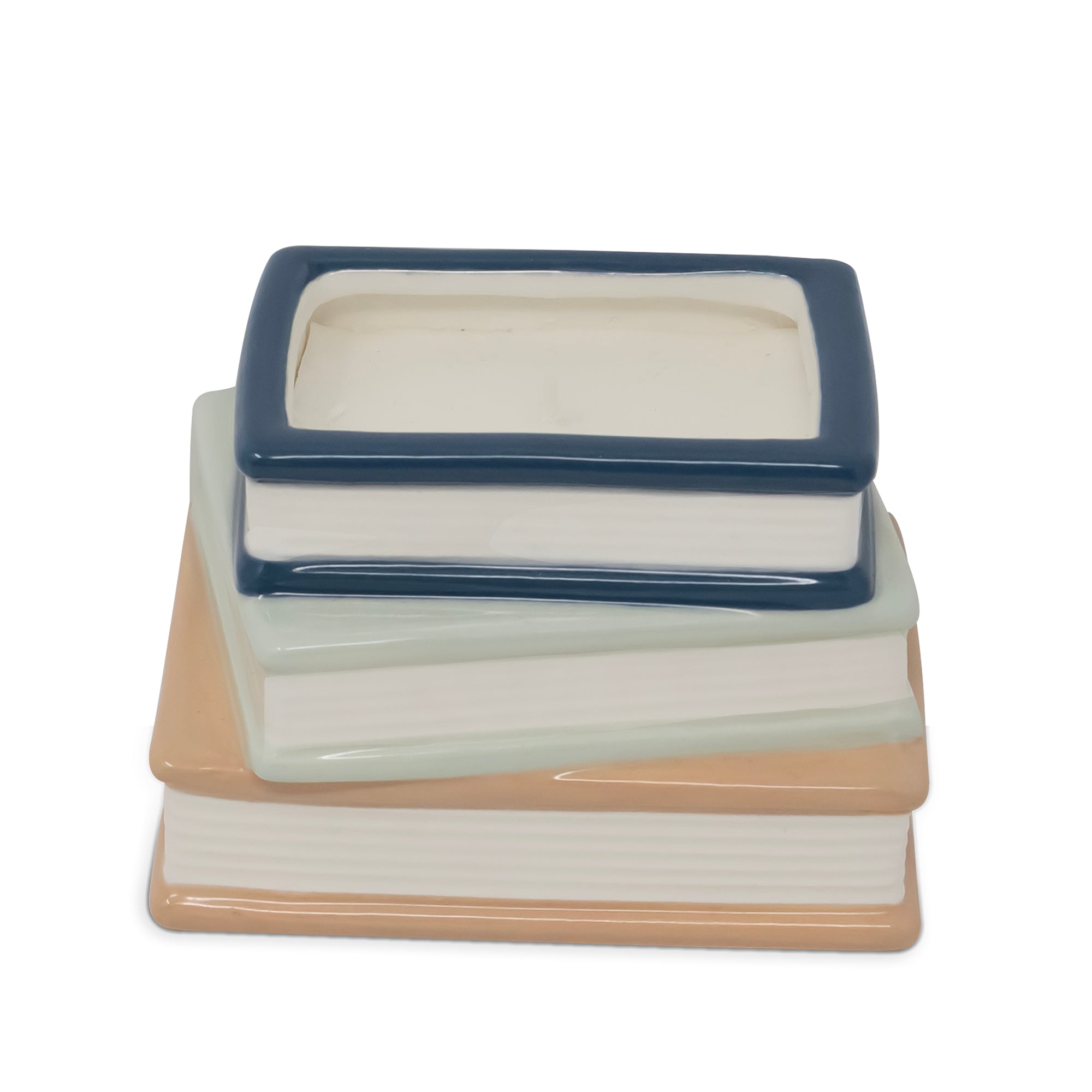 A ceramic stack of three books with a small rectangular book-shaped dish or container on top, shown on a plain white background.