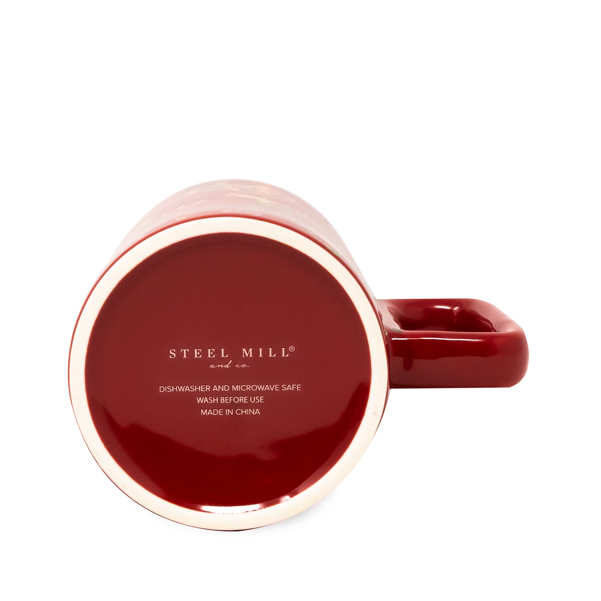 A glossy dark red ceramic mug shown from a top-down angle, revealing the printed 'STEEL MILL' brand name and safety text on the inside bottom. The mug features a matching red handle and a light beige rim, set against a plain white background.