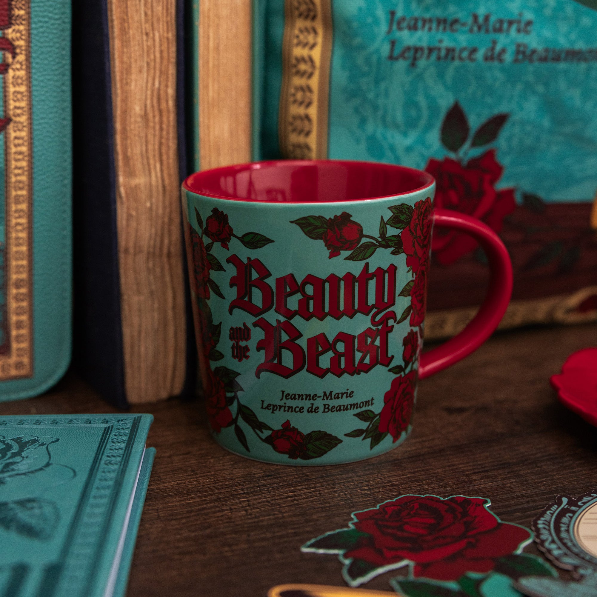Mug with 'Beauty and the Beast' design and red interior on a white background