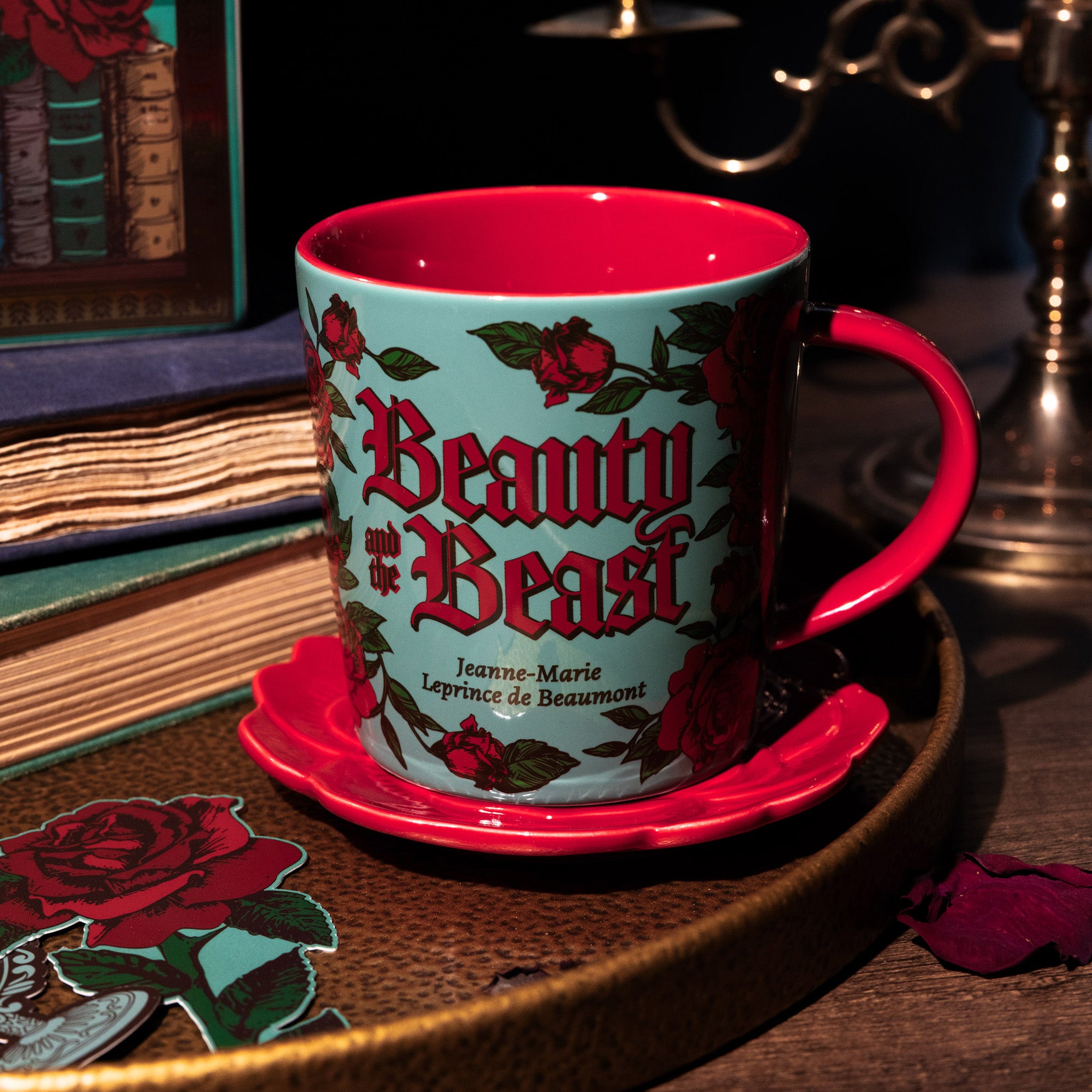 Mug with 'Beauty and the Beast' design on a wooden surface with books in the background