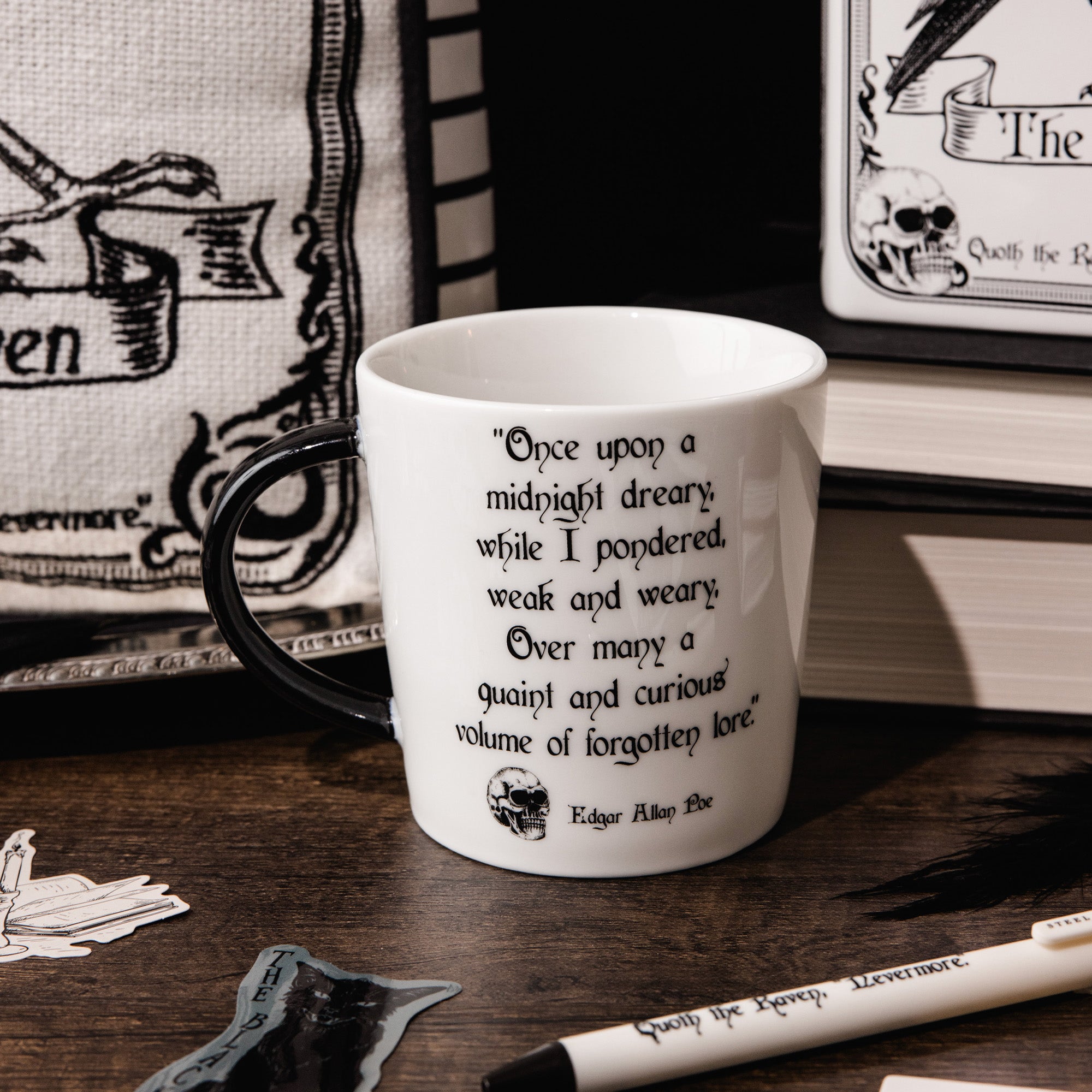 A white ceramic mug with a black handle and black printed text featuring a Edgar Allan Poe quote and skull illustration, shown on a white background.