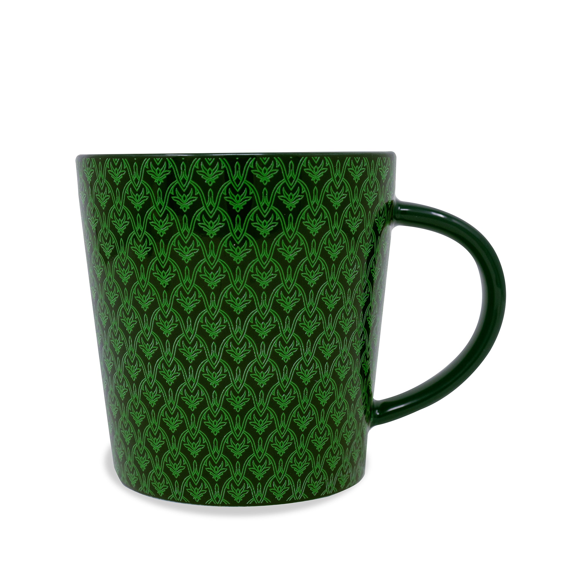 Green mug with a witch and broom design and text on a white background