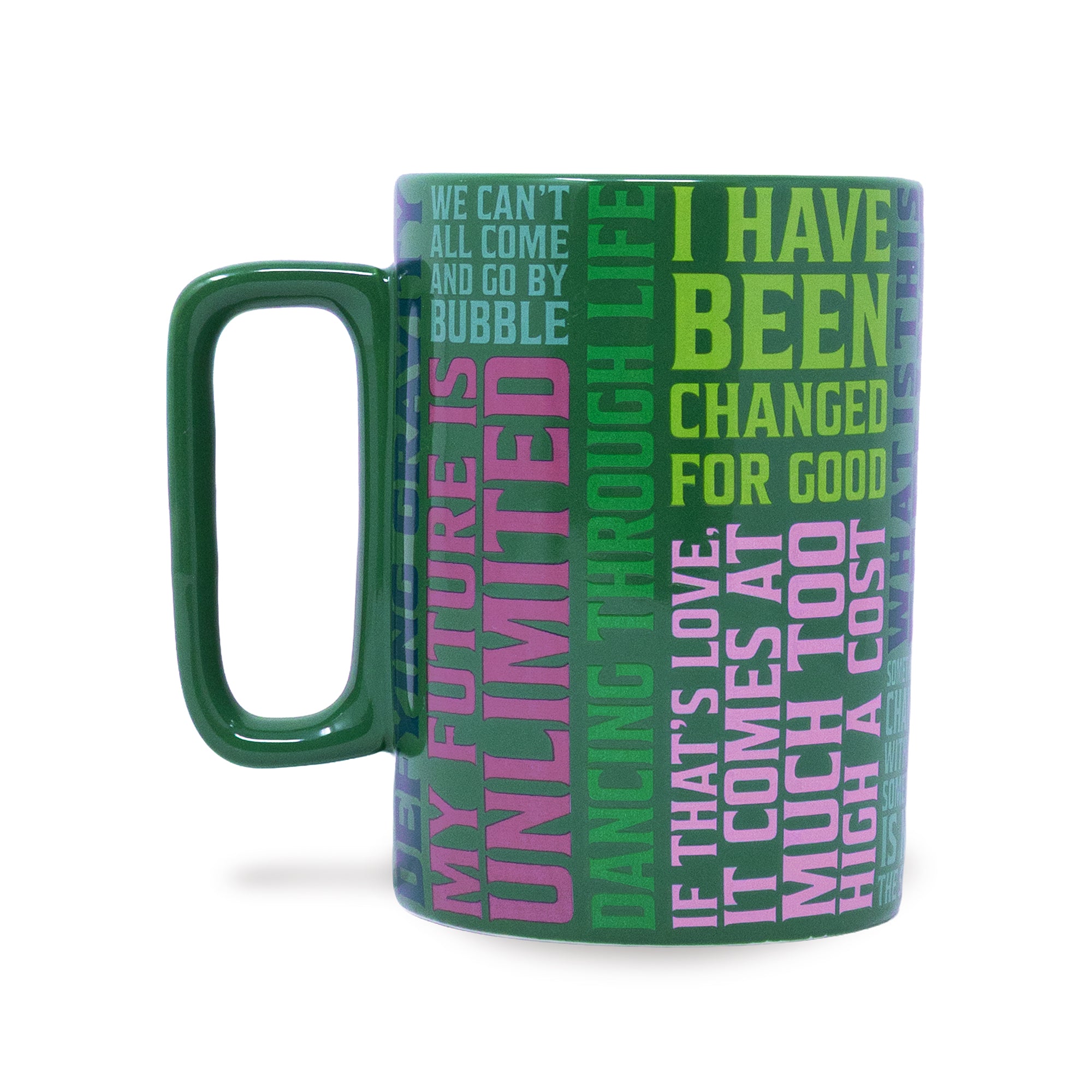 A green ceramic mug with a handle, featuring a wrap-around design of motivational text in pink, green, and purple on a white background.
