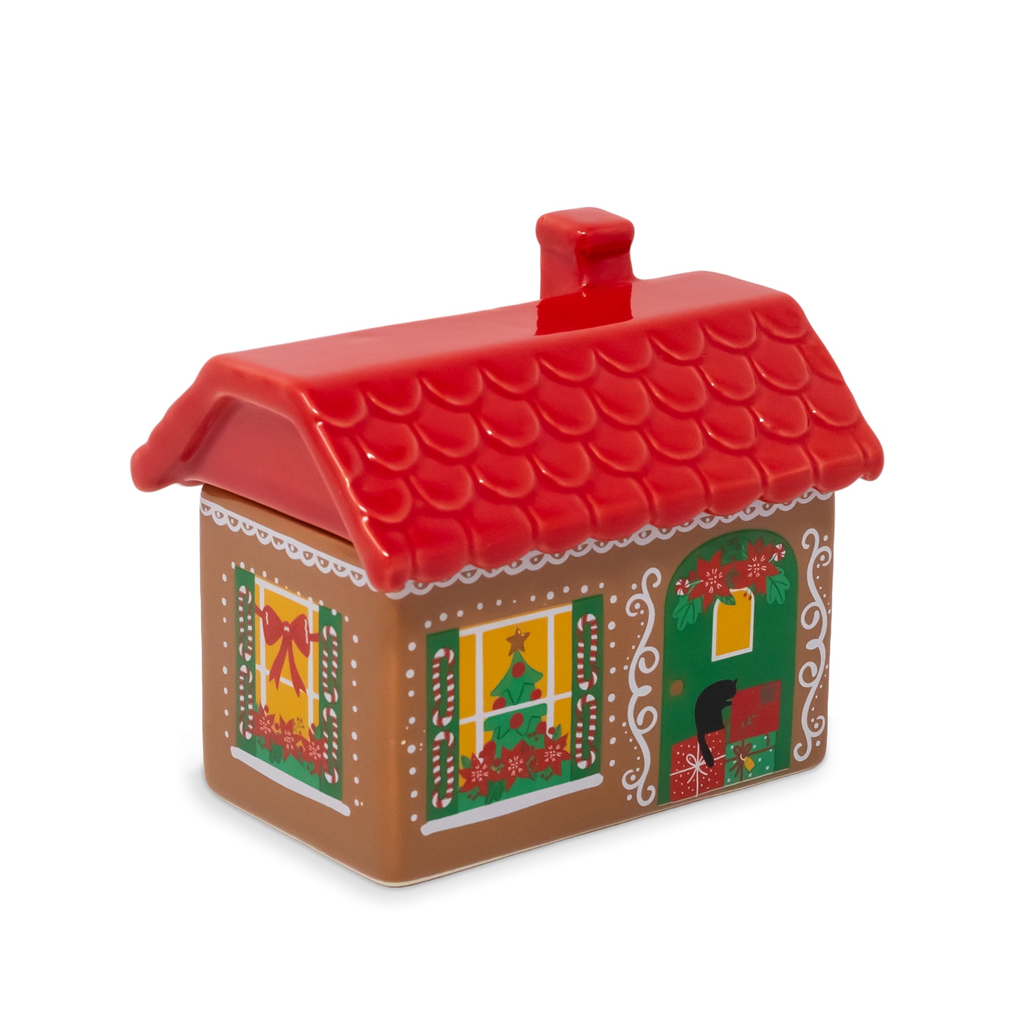 A gingerbread house-shaped ceramic container with a red scalloped roof, decorated with Christmas window and door designs on a white background.