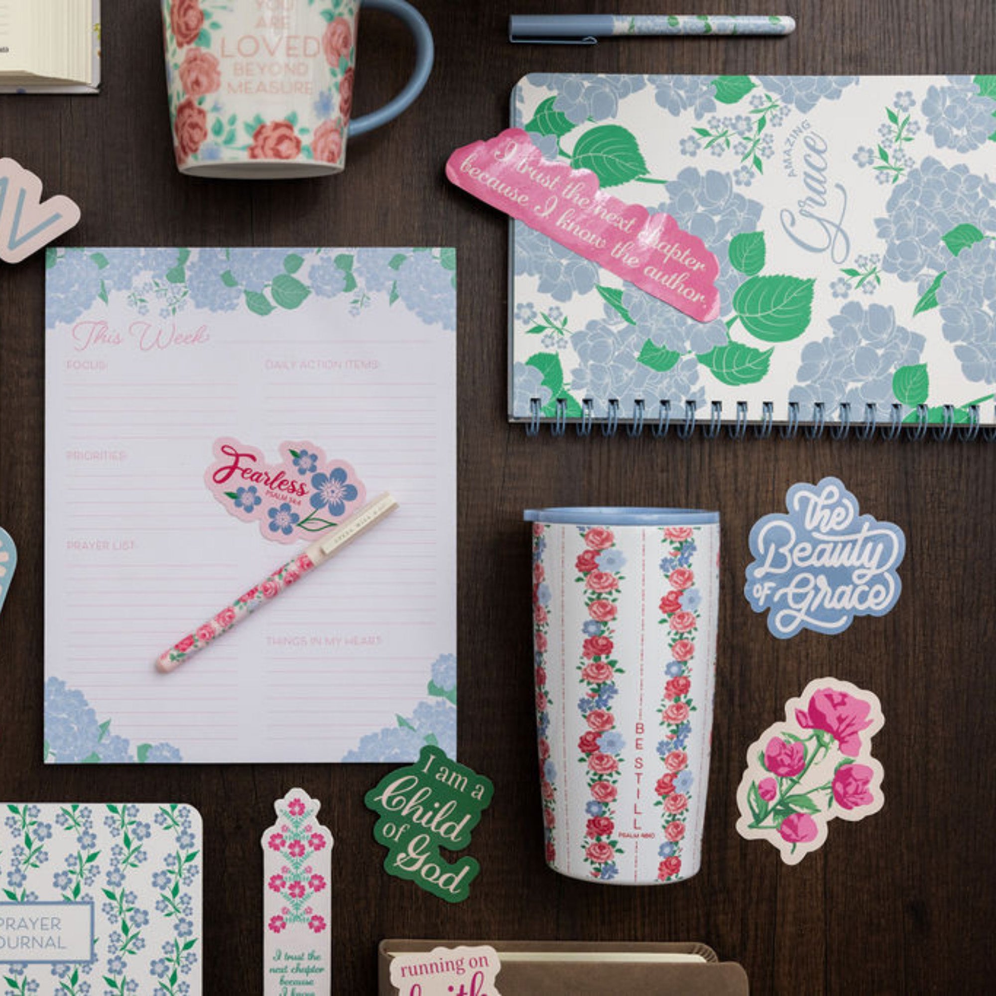 Stationery items with floral designs on a wooden surface