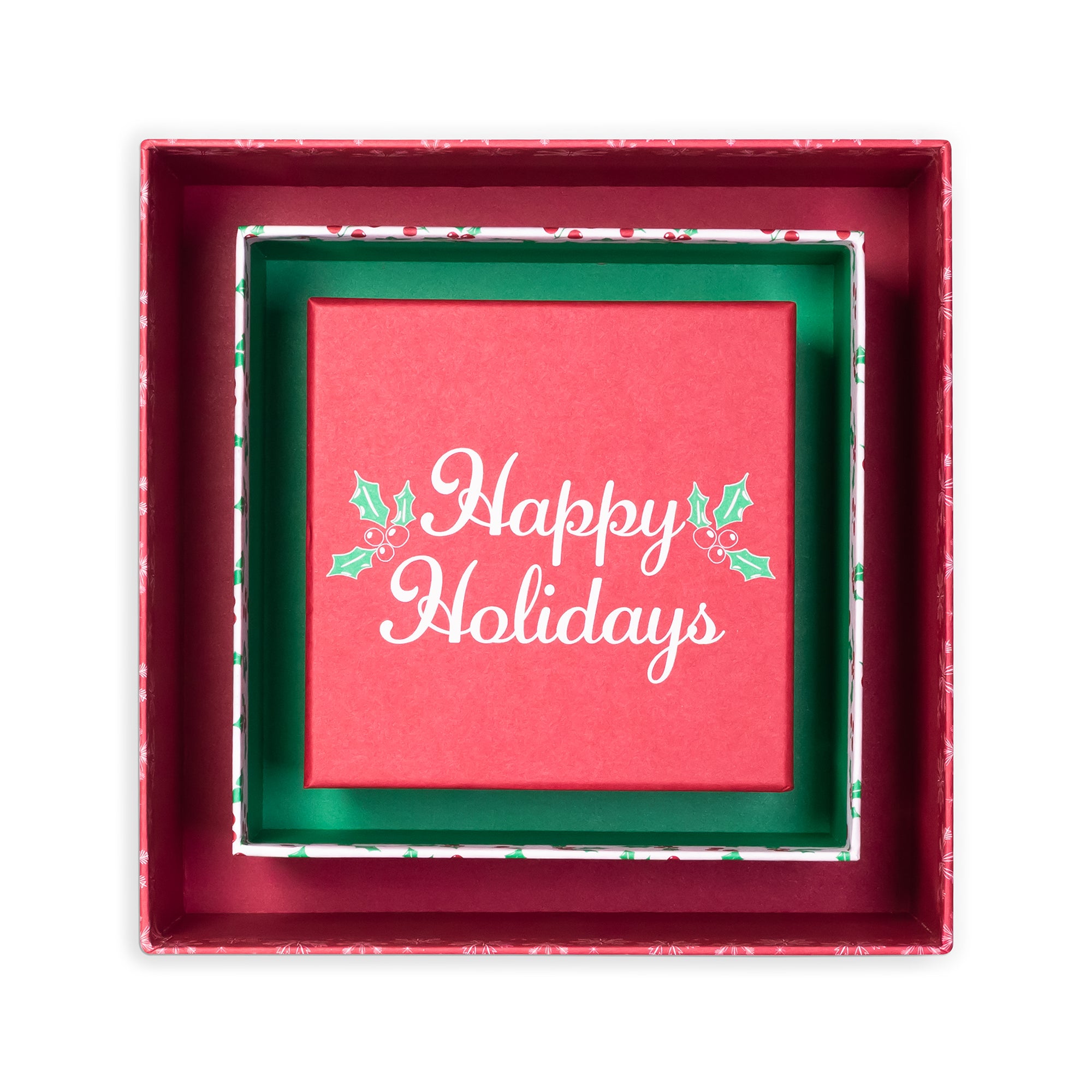 A square red gift box with a festive green inner liner and a red center card printed with 'Happy Holidays' in white script, decorated with small holly leaves, on a plain white background.