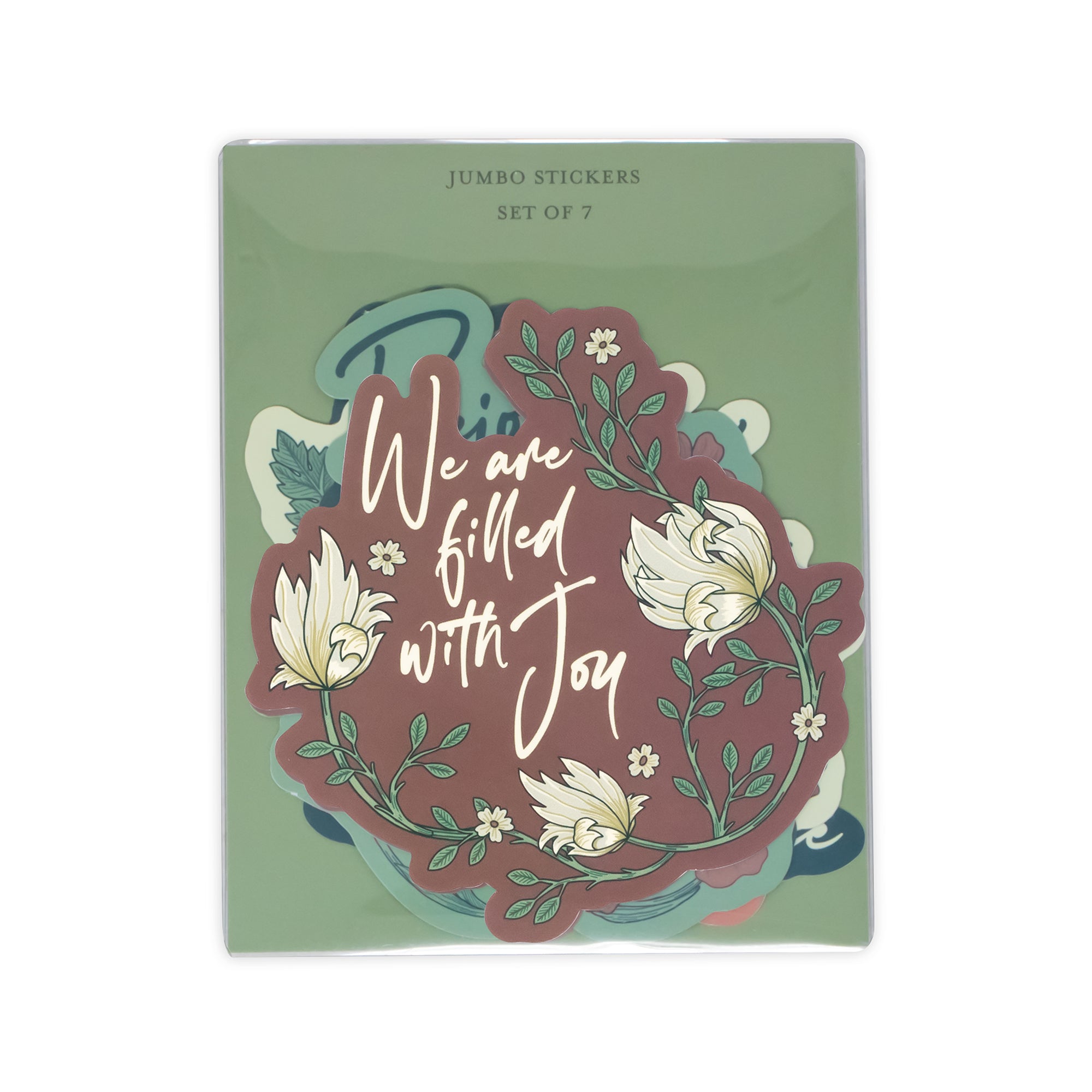 A set of seven jumbo stickers in a clear plastic sleeve, featuring a green backing card with a central sticker design that reads 'We are filled with Joy' in white script over a dusty rose and teal floral wreath.