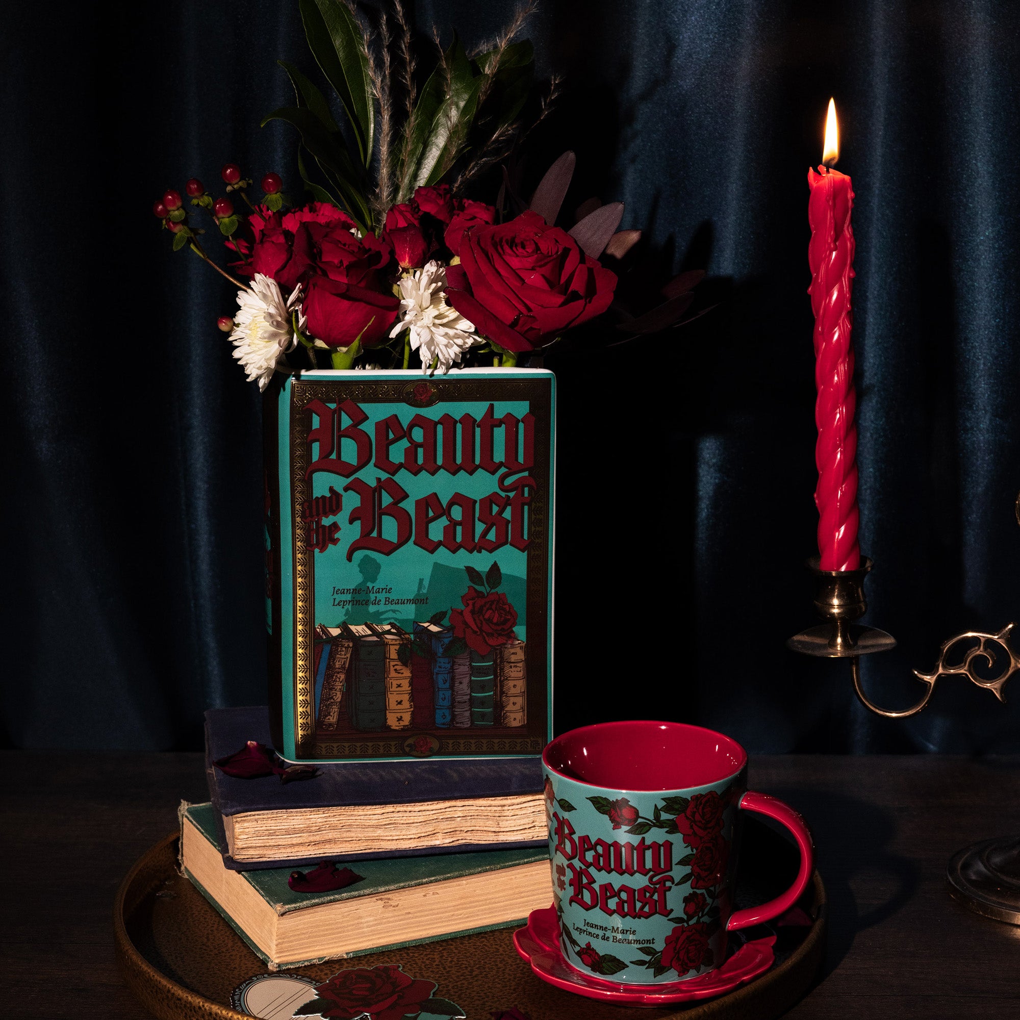 teal book shaped vase with beauty and the beast cover with flowers inside and matching mug