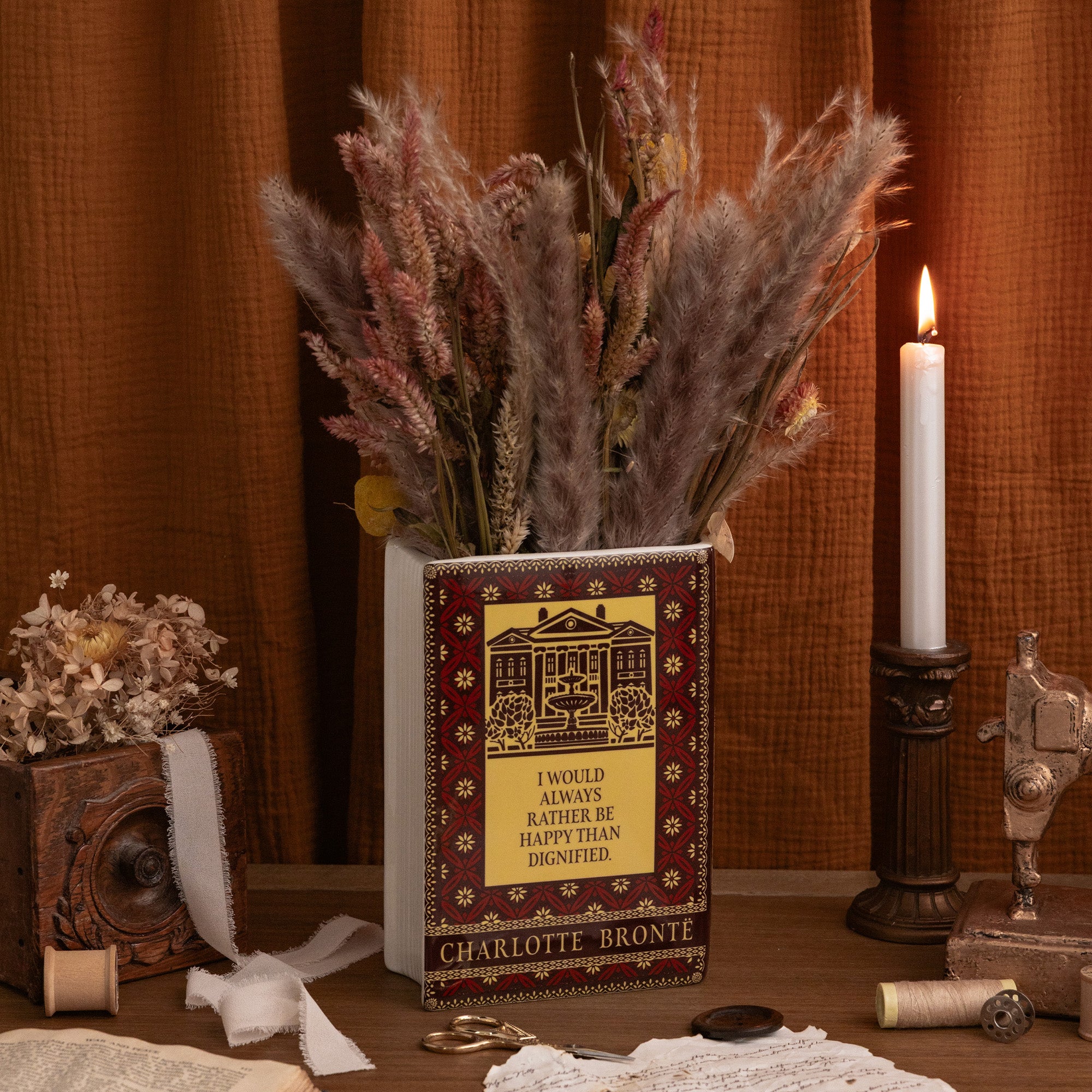 back view of decorative book-shaped vase featuring Jane Eyre cover art, shown on a plain white background. The design includes a dark brown and black background with ornate gold patterns, the title 'Jane Eyre' on the spine and front, and a gold silhouette portrait.