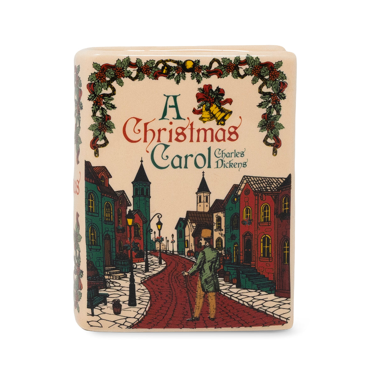 A square decorative book cover or plaque featuring an illustrated Christmas street scene from A Christmas Carol by Charles Dickens, with a green garland and red ornaments across the top, on a plain white background.