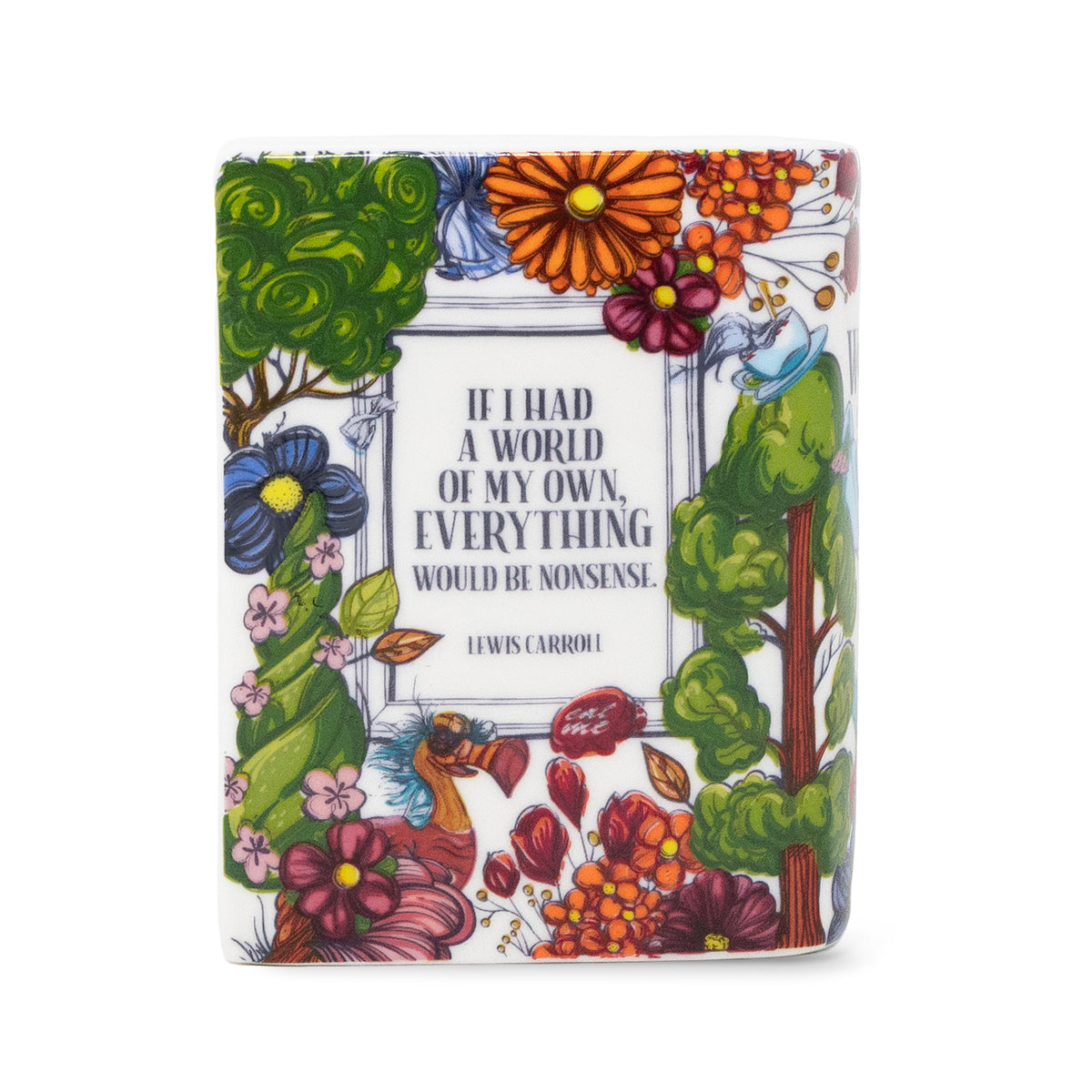 A square candle with a white cover featuring a colorful floral border and a central quote from Lewis Carroll: 'IF I HAD A WORLD OF MY OWN, EVERYTHING WOULD BE NONSENSE.'.