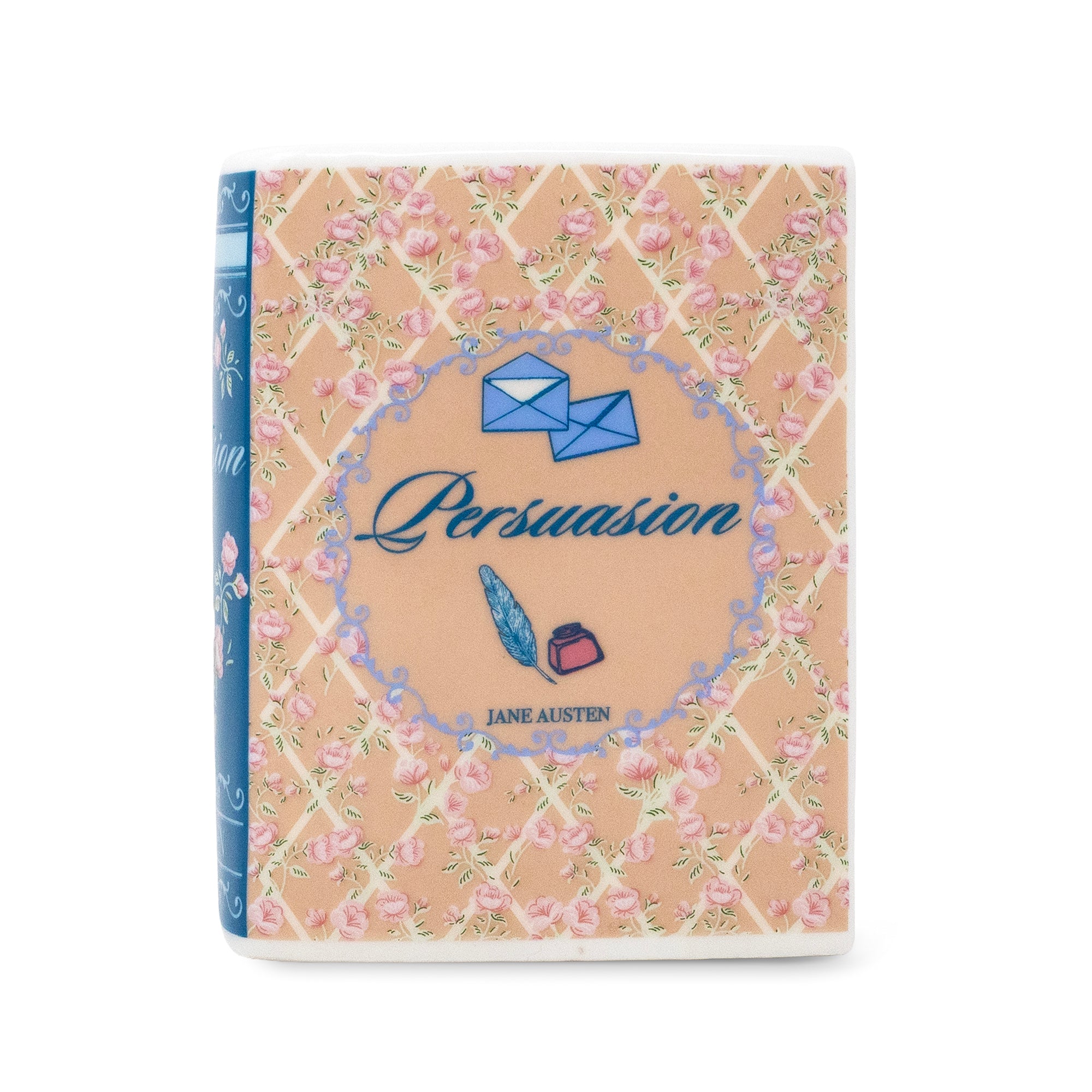 book candle of Jane Austen's 'Persuasion' featuring a peach-beige cover decorated with a pink rose trellis pattern, blue envelopes, and blue script title text, shown on a plain white background.