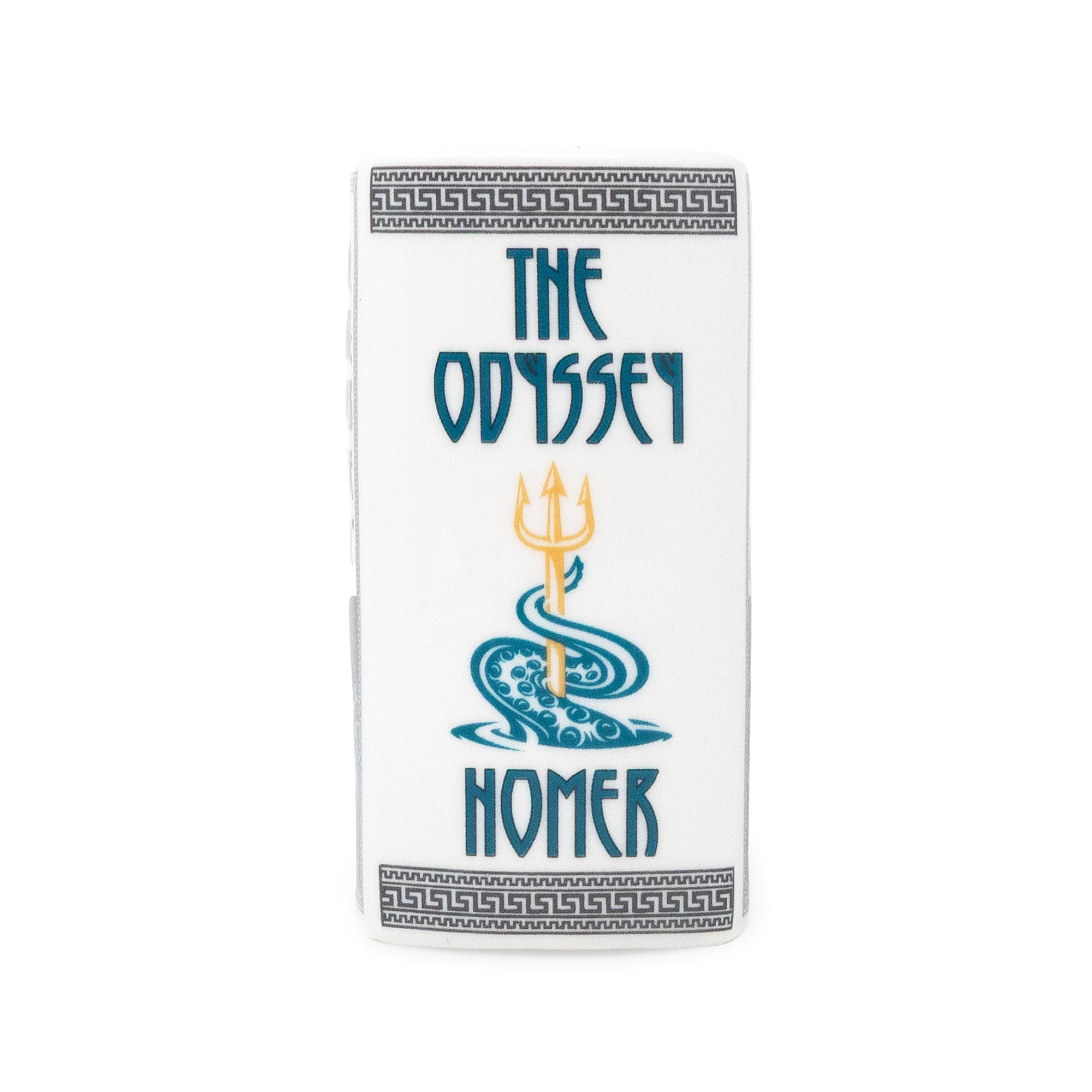 A white rectangular candle featuring the title 'THE ODYSSEY HOMER' in blue text with a central trident and wave illustration, plus Greek key decorative borders at the top and bottom, shown on a plain white background.