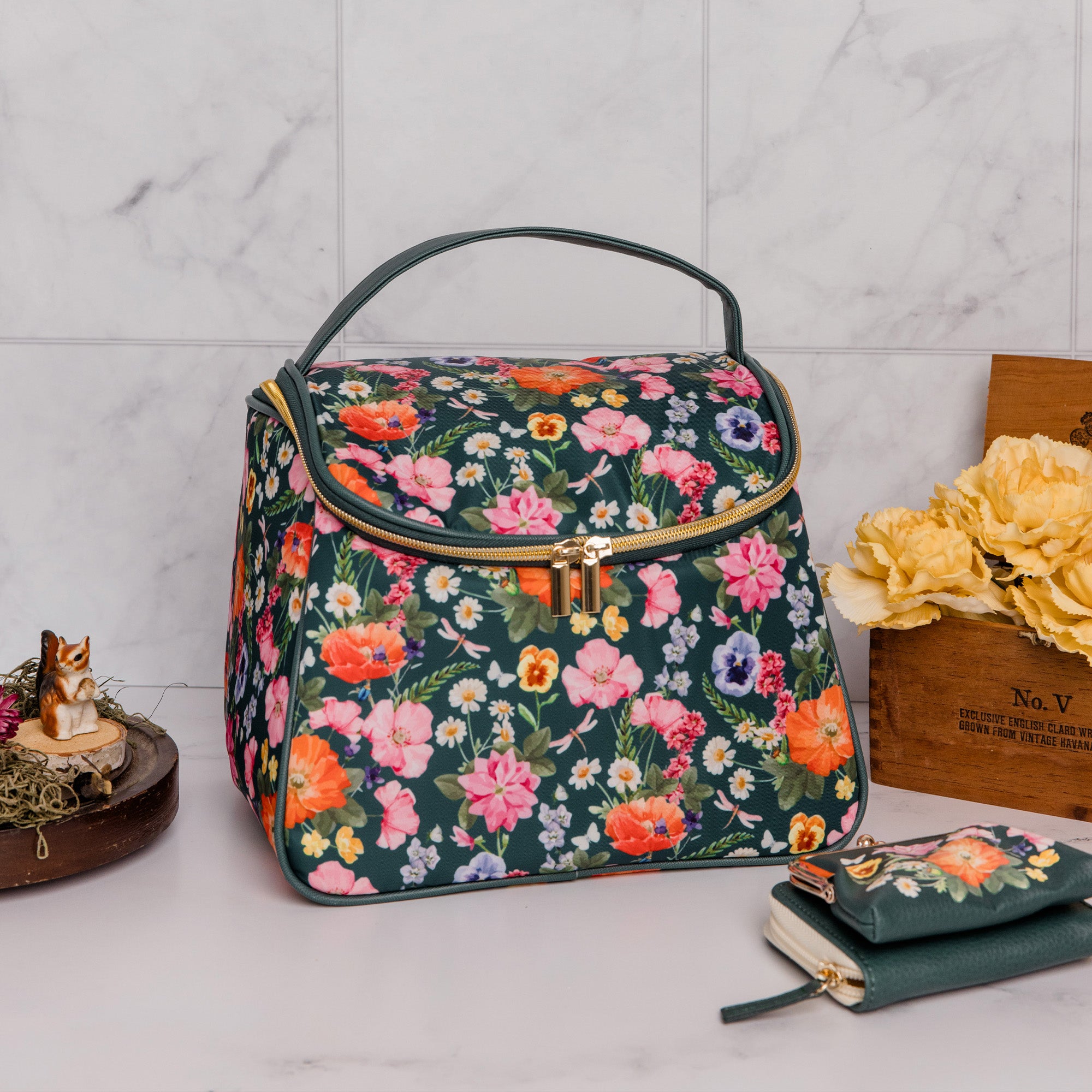 dark green lunch bag with colorful realistic floral print in a kitchen setting