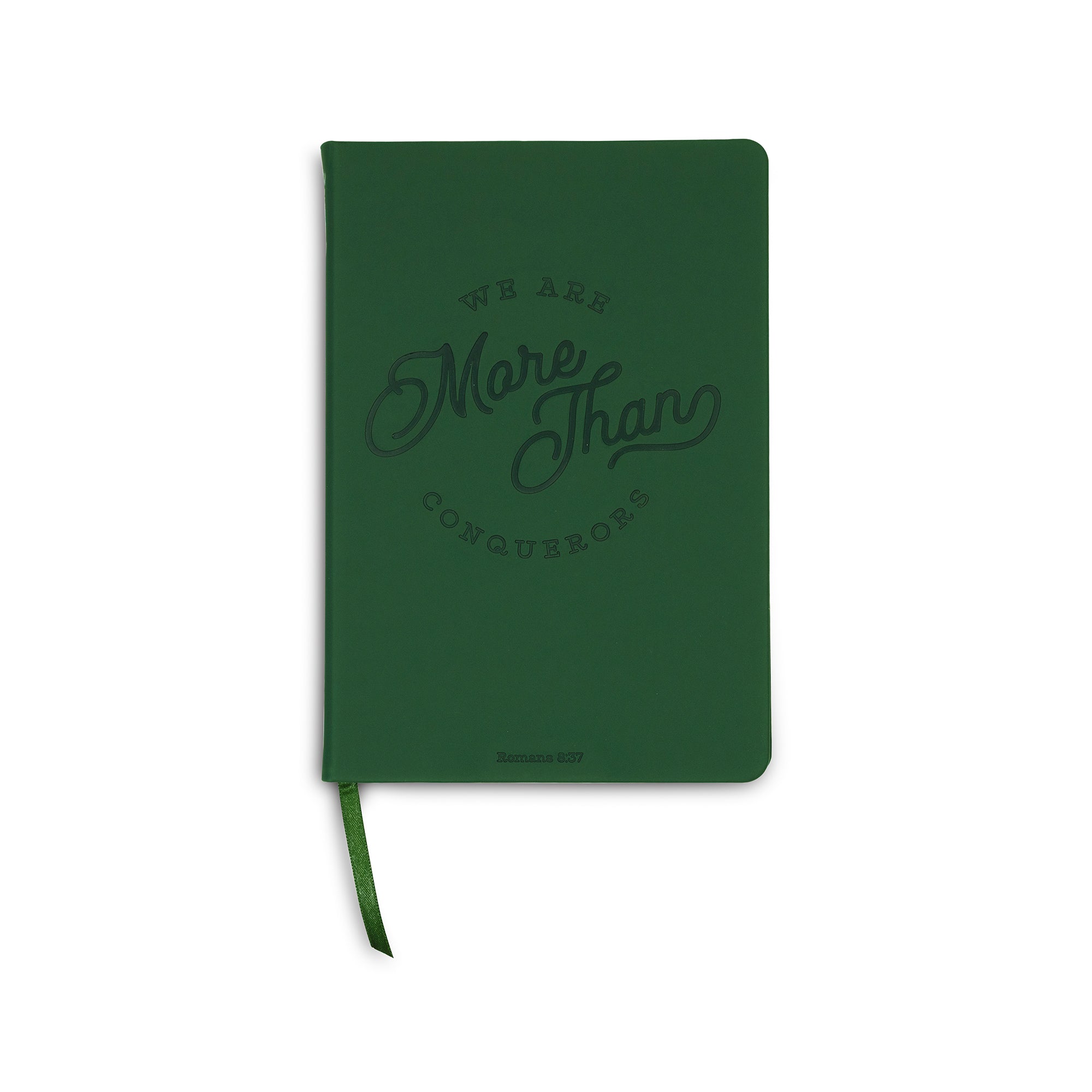 Green notebook with 'We Are More Than Conquerors' text on a white background