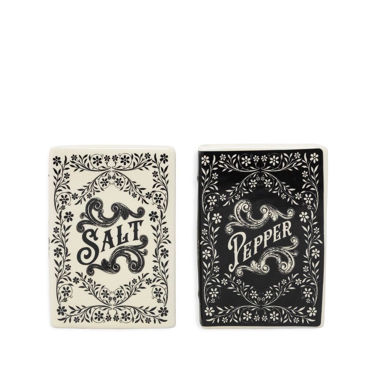 Two decorative rectangular salt and pepper shakers shown side by side on a plain white background. The left shaker is off-white with black floral border artwork and the word 'SALT' in the center.