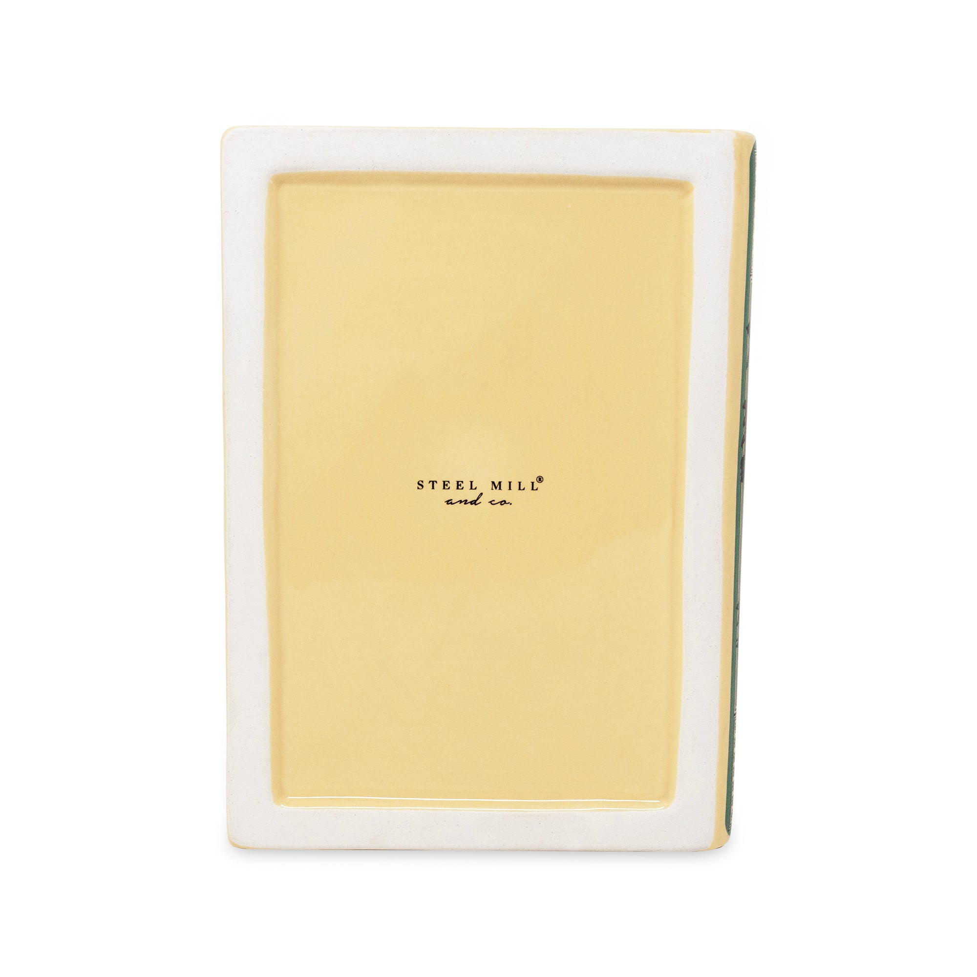 bottom of rectangular ceramic with a glossy pale yellow insert and a white outer border, featuring the 'STEEL MILL and co' logo in black text in the center.
