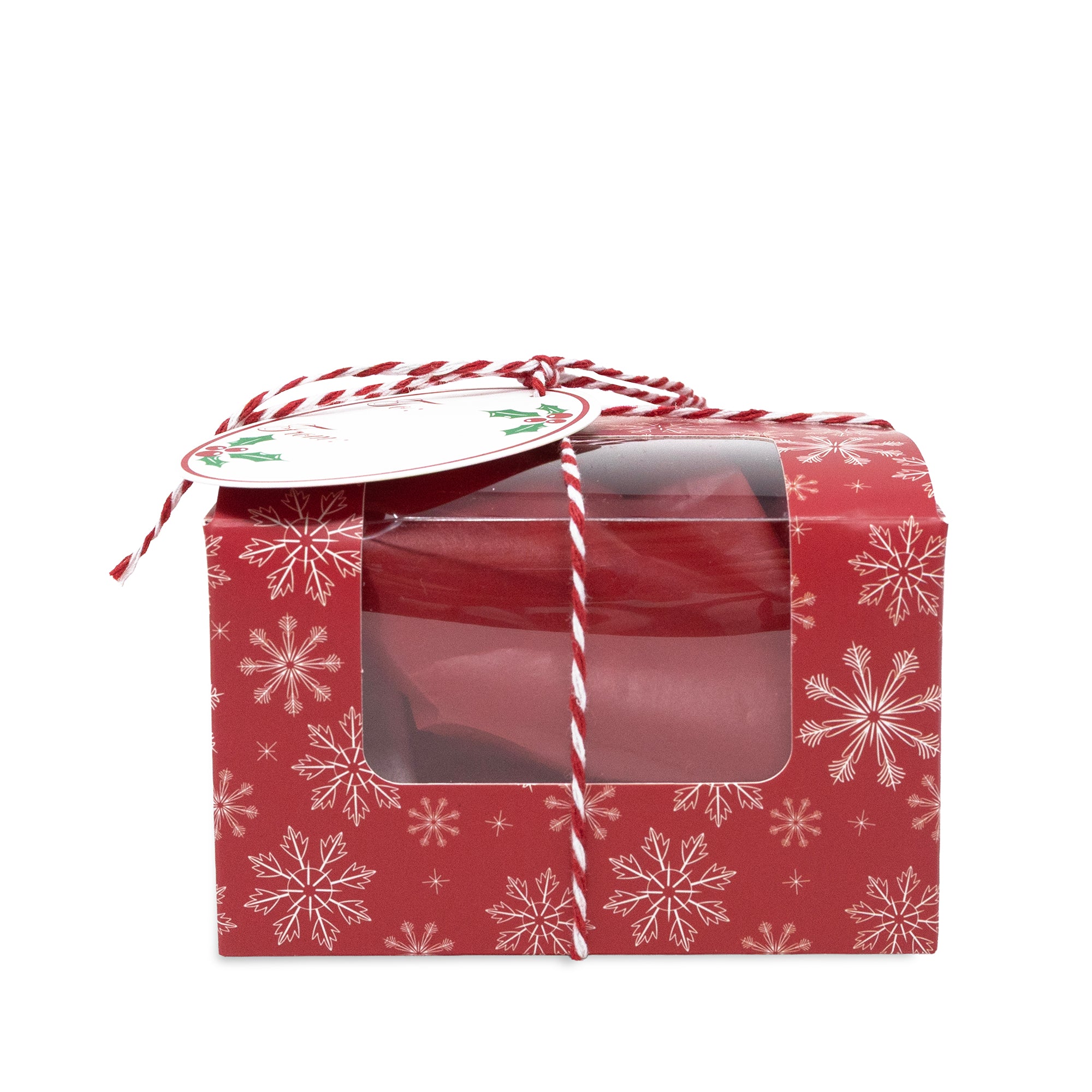A red gift box with a clear plastic window, decorated with white snowflakes and tied with red-and-white striped string and a round paper tag.