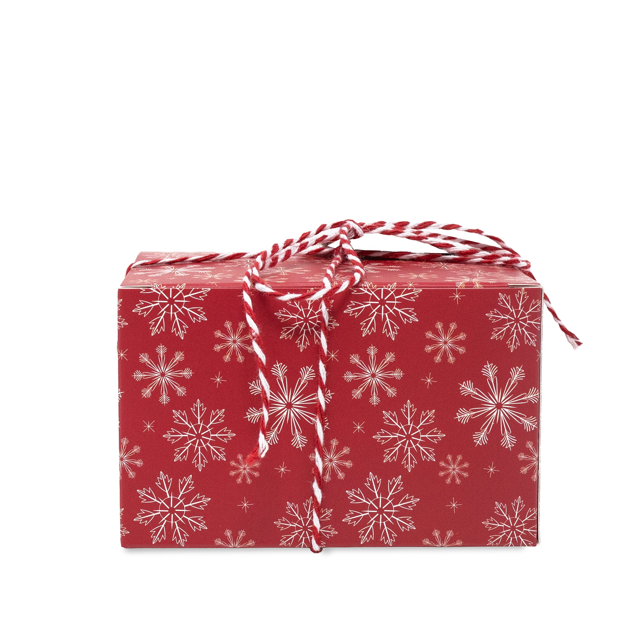 A rectangular gift box wrapped in red paper with a white snowflake pattern, tied with a red and white striped string, on a plain white background.