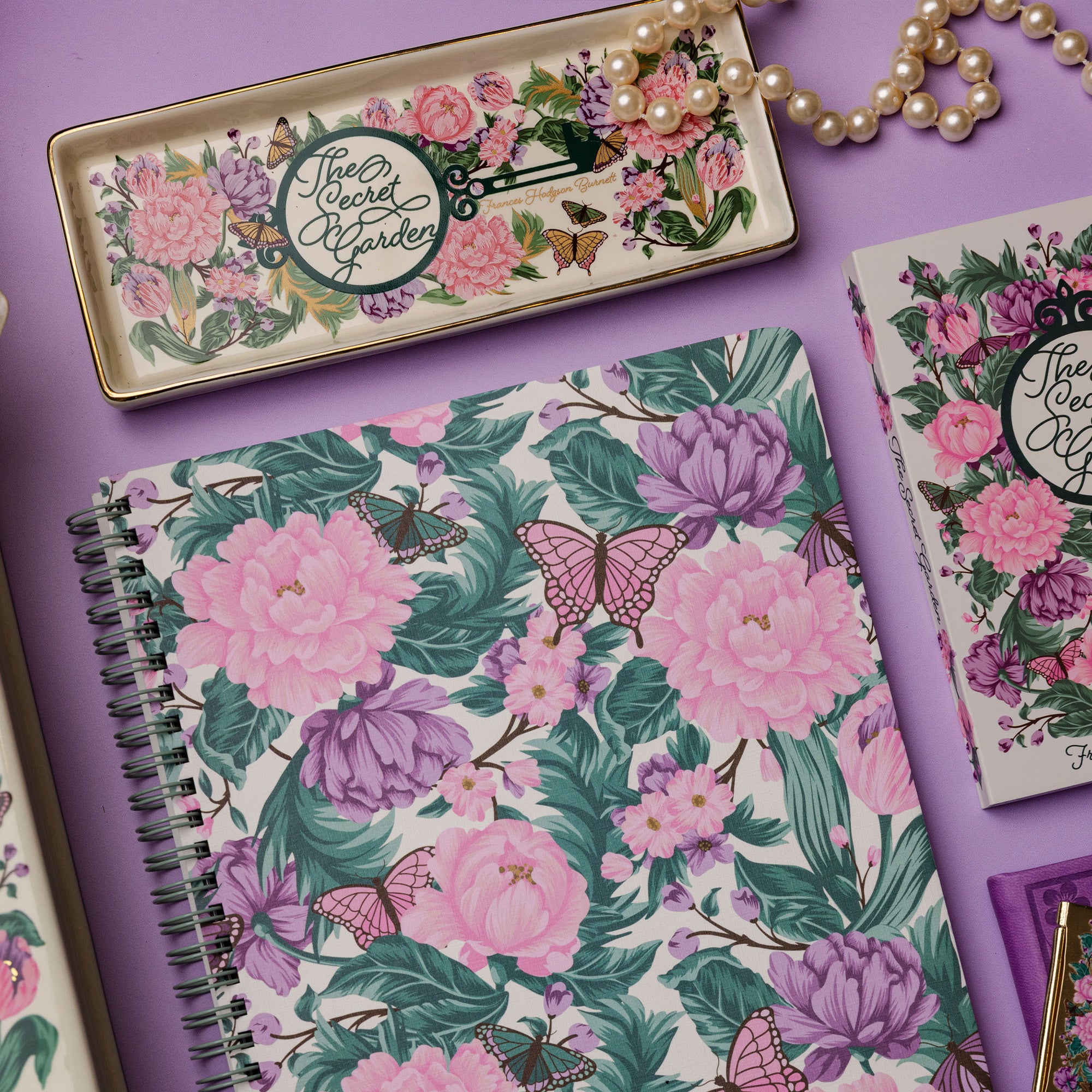 Floral notebook and stationery set on a purple background