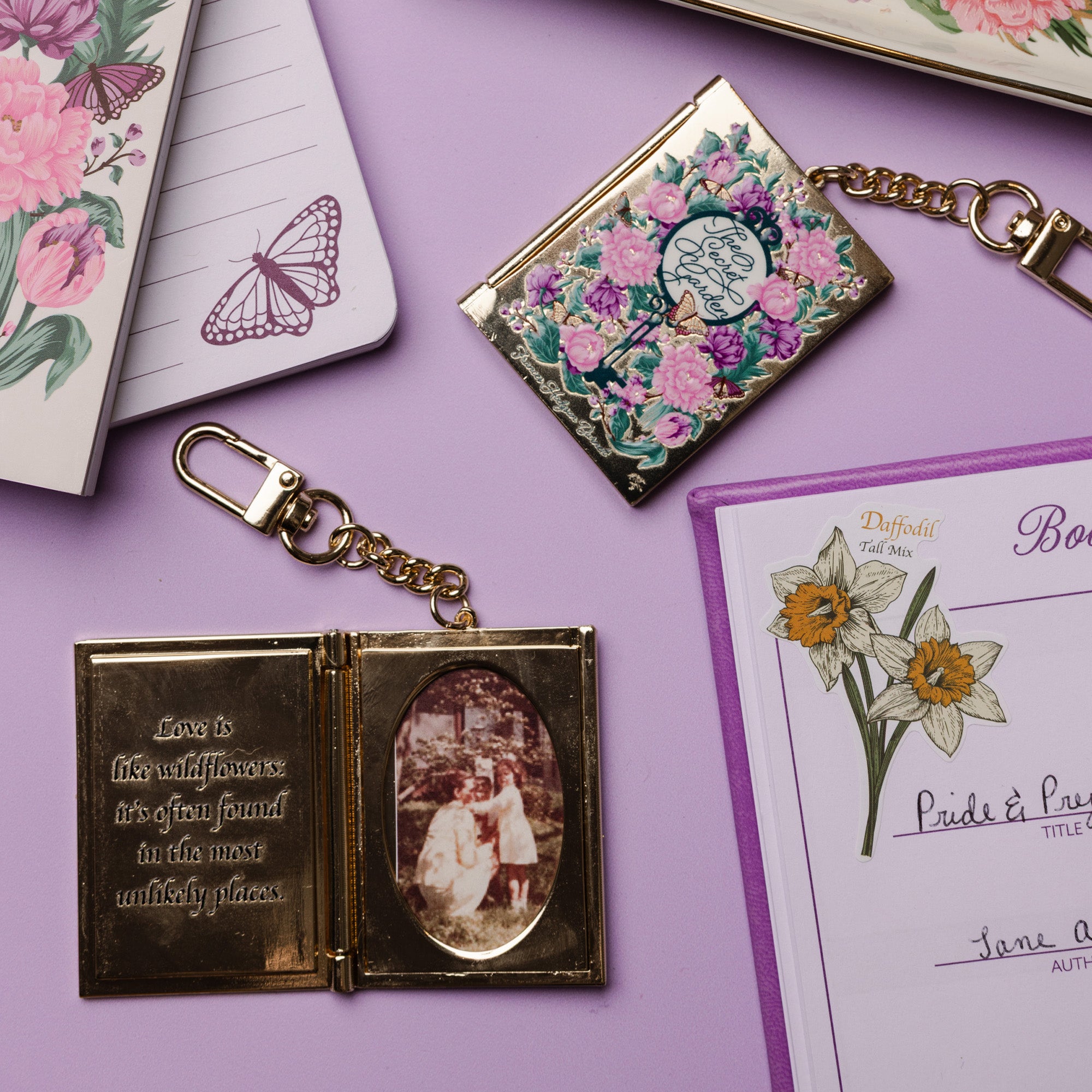 Decorative keychain with floral design and vintage-style photo on a purple surface.