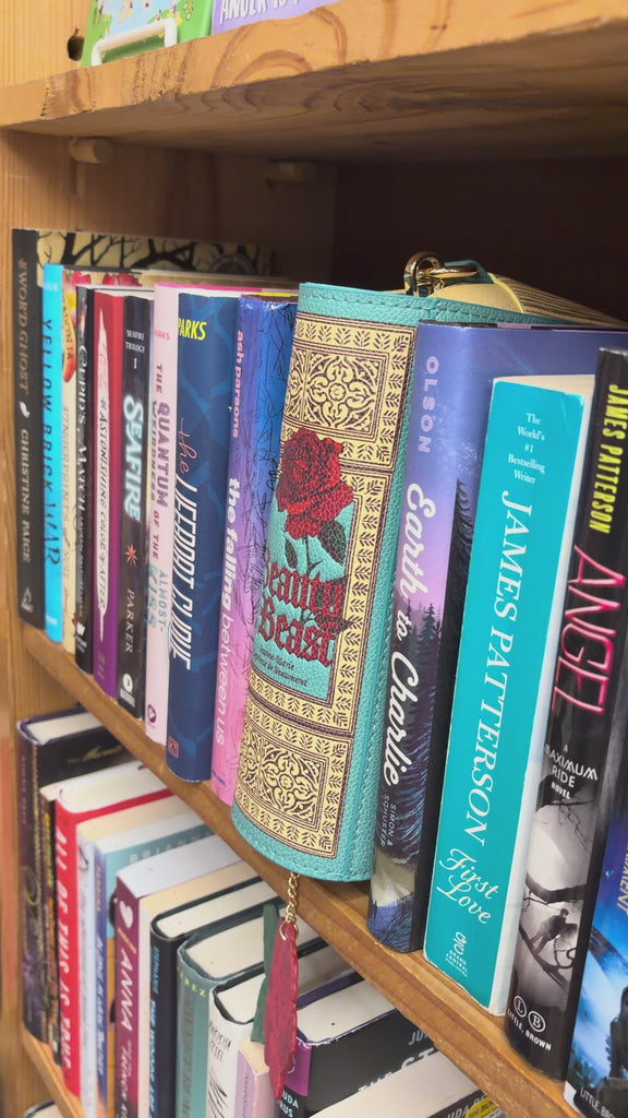 model pulling beauty and the beat crossbody bag out of library shelves