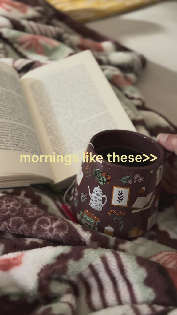model drinking coffee from mug and reading a book