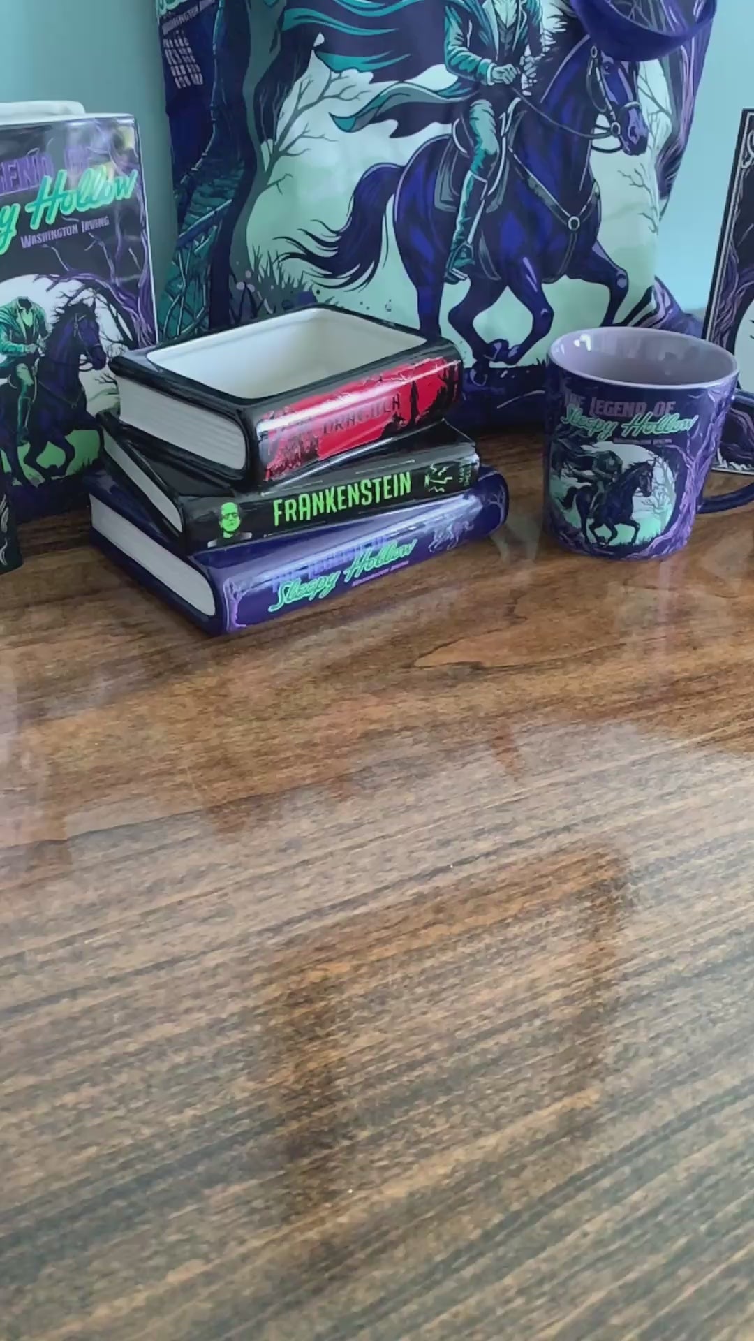 model showcasing s stack of three rectangular book-shaped vase on a white background, labeled Dracula, Frankenstein, and The Legend of Sleepy Hollow.