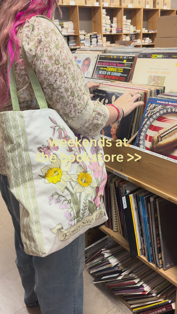 model carrying wildflowers tote
