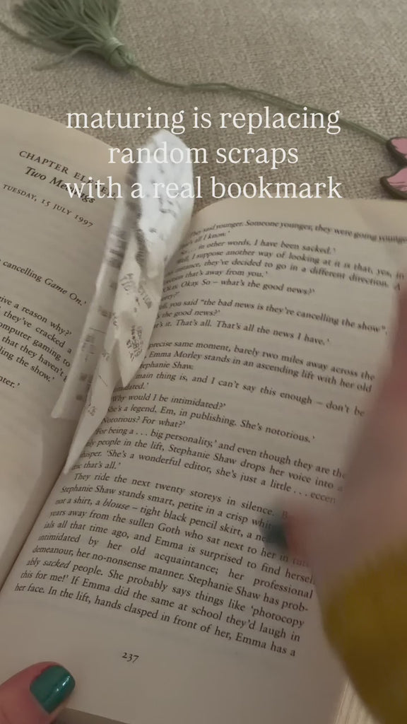 model using flower bookmark to hold a place in their book