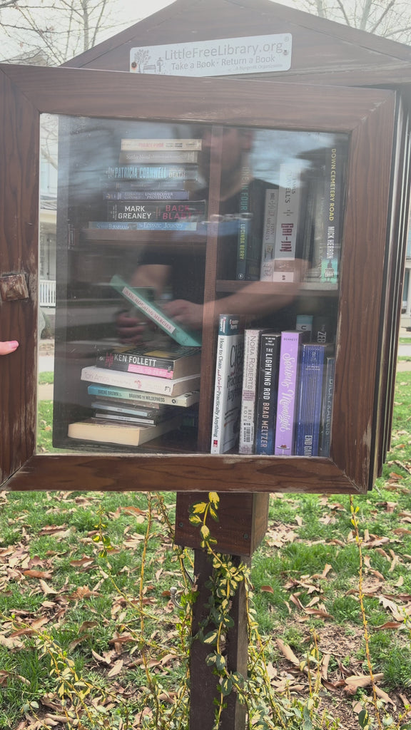 model putting various withering heights and wizard of oz items in a free little library
